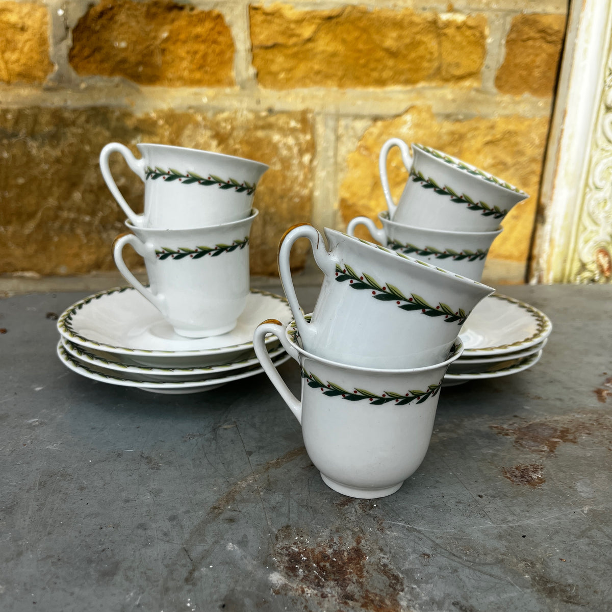 Vintage Limoges porcelain tea set featuring delicate green garland decoration around the rims of the pieces