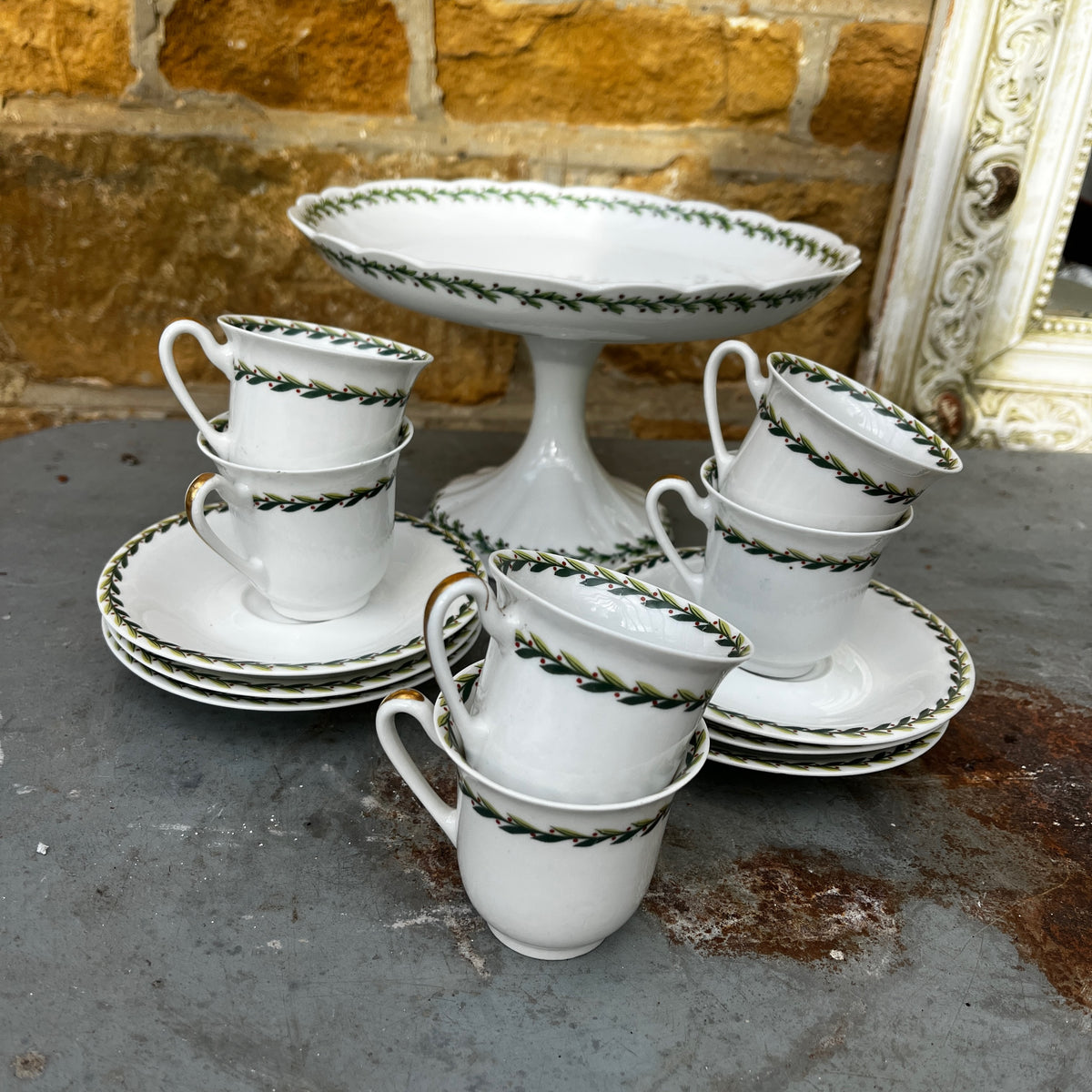 Vintage Limoges porcelain tea set featuring delicate green garland decoration around the rims of the pieces
