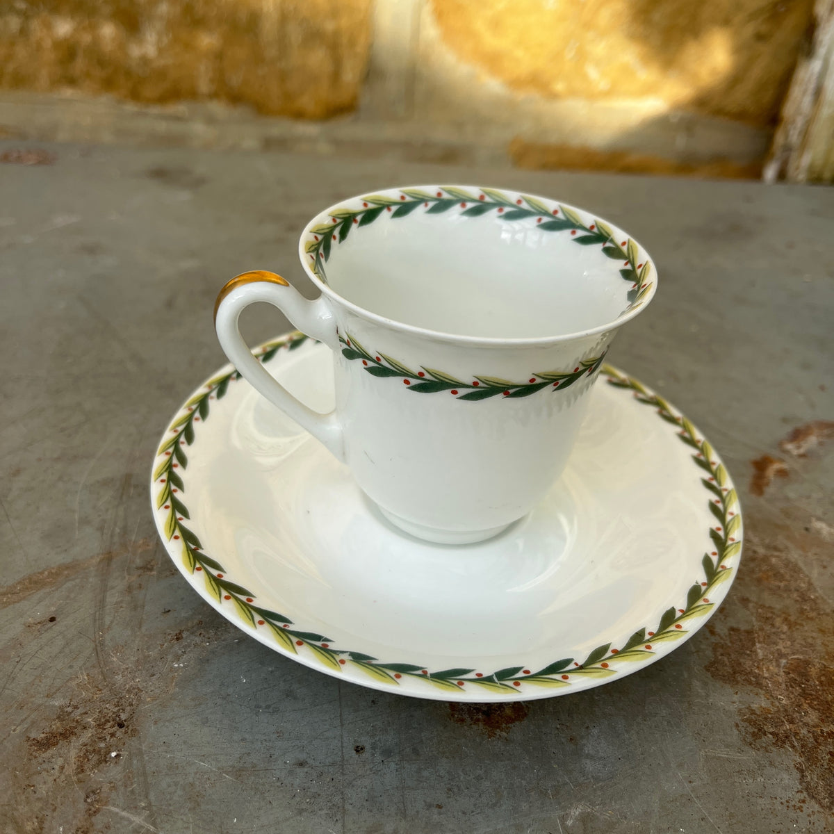 Vintage Limoges porcelain tea set featuring delicate green garland decoration around the rims of the pieces