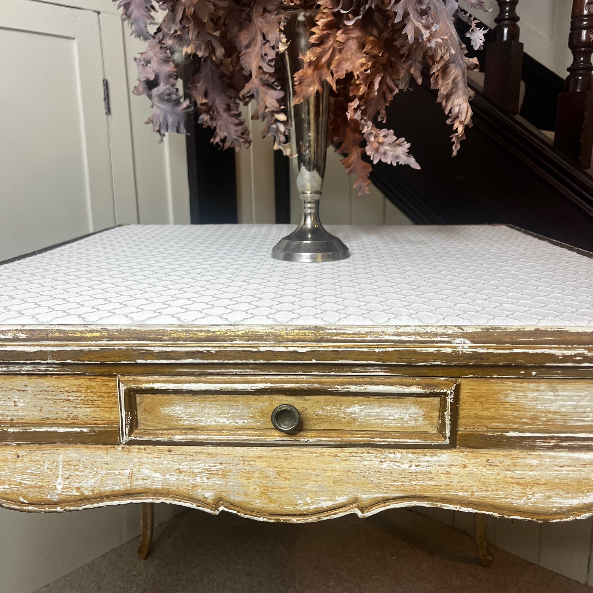 Square Louis-Philippe–style table with a warm wood finish, featuring clean classical lines, gently rounded edges, and small drawers built into all four sides, supported by four turned legs.
