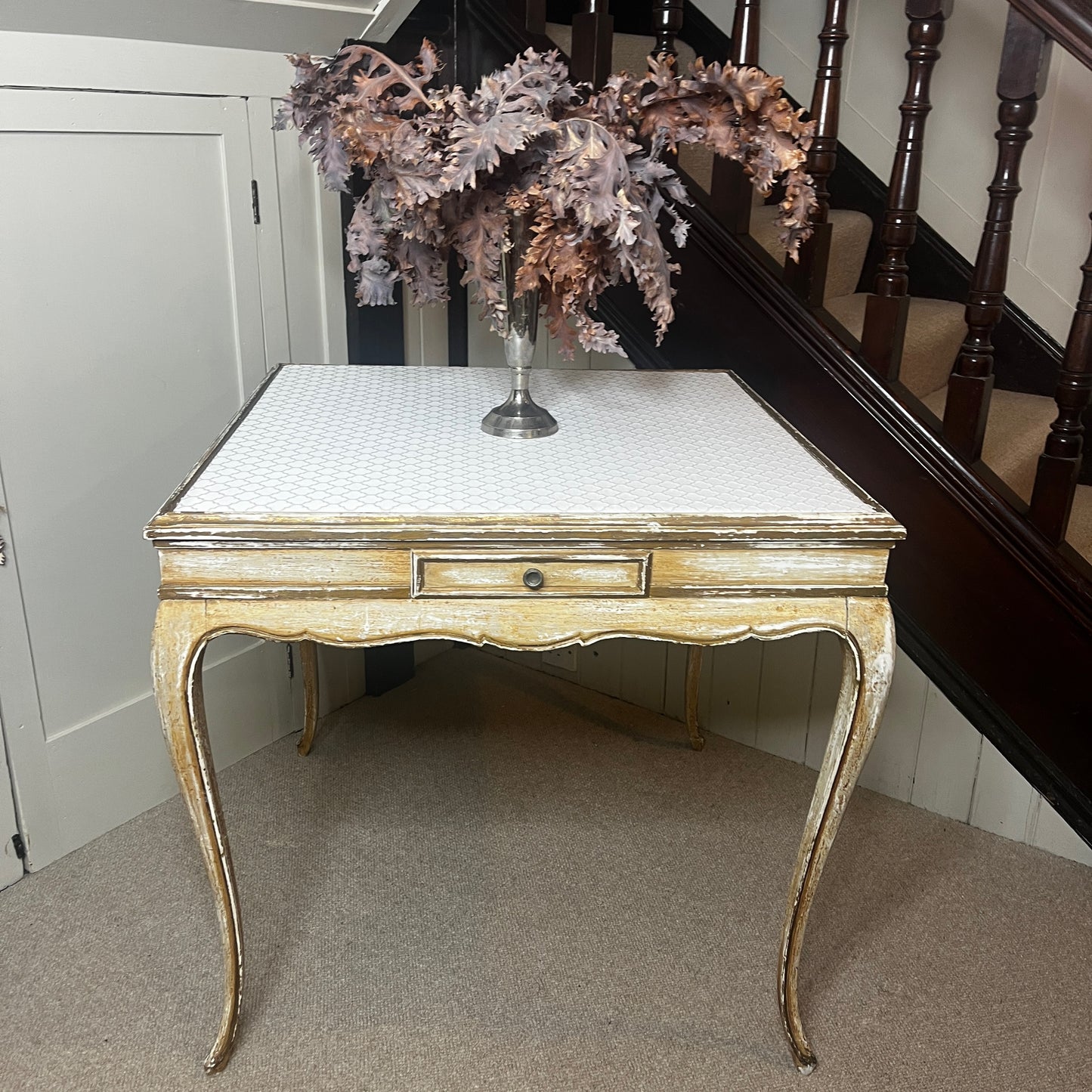 Square Louis-Philippe–style table with a warm wood finish, featuring clean classical lines, gently rounded edges, and small drawers built into all four sides, supported by four turned legs.
