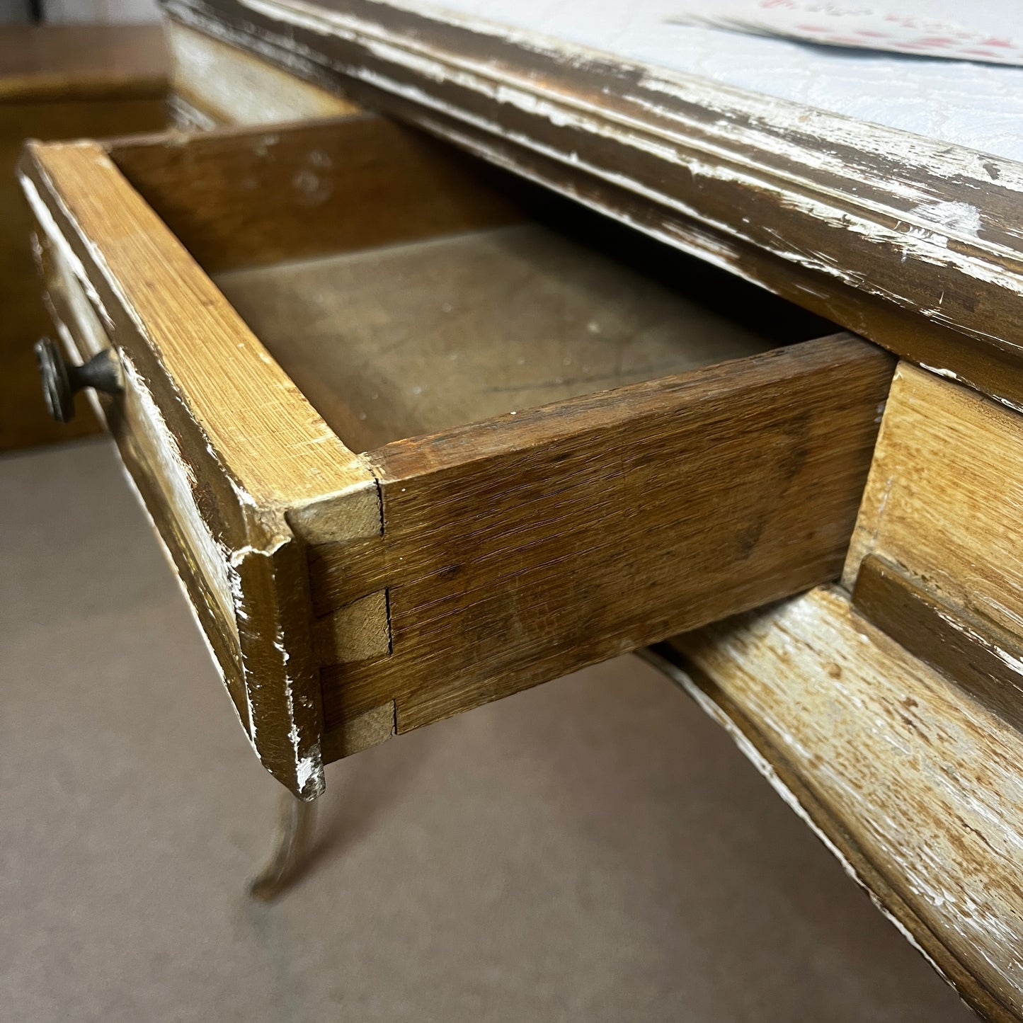 Square Louis-Philippe–style table with a warm wood finish, featuring clean classical lines, gently rounded edges, and small drawers built into all four sides, supported by four turned legs.
