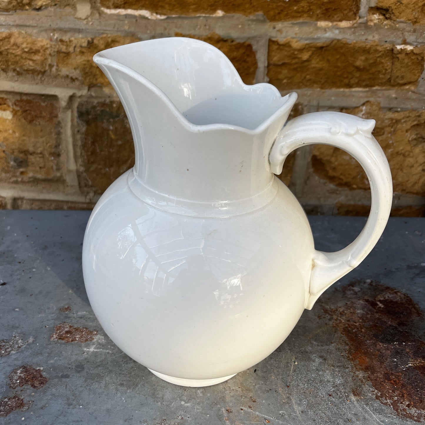 Large ceramic jug from Maastricht, featuring a sturdy handle, rounded body, and traditional glazed finish with classic Dutch pottery styling.
