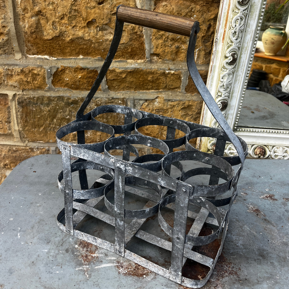 Rustic French vintage bottle carrier made of galvanized metal, featuring six bottle compartments and a turned wooden center handle