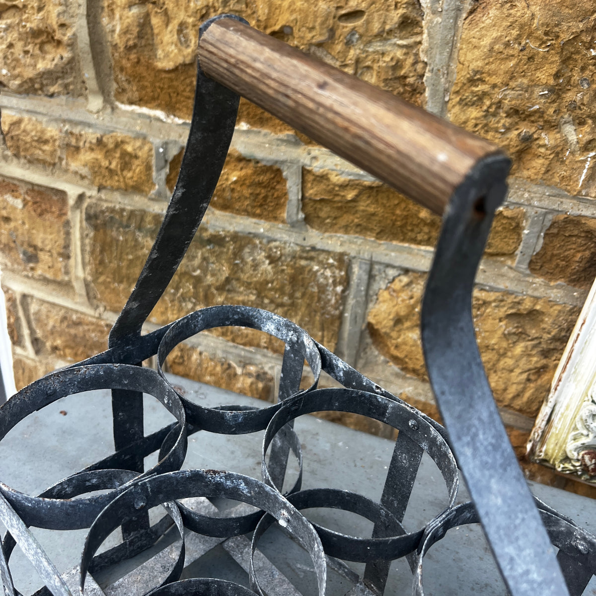 Rustic French vintage bottle carrier made of galvanized metal, featuring six bottle compartments and a turned wooden center handle