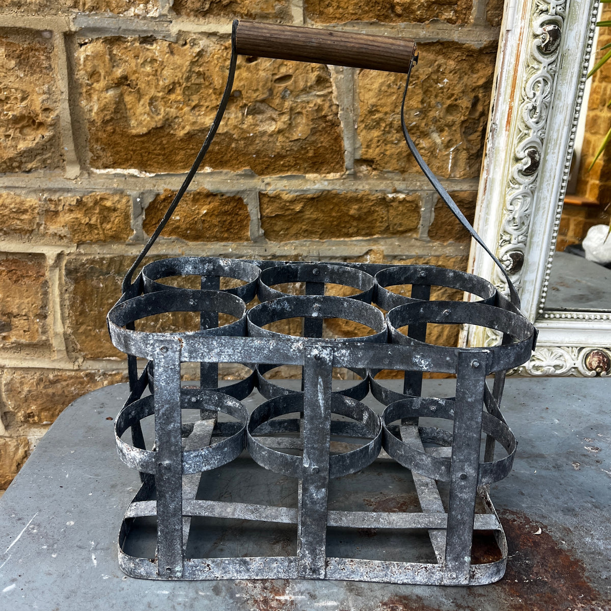 Rustic French vintage bottle carrier made of galvanized metal, featuring six bottle compartments and a turned wooden center handle