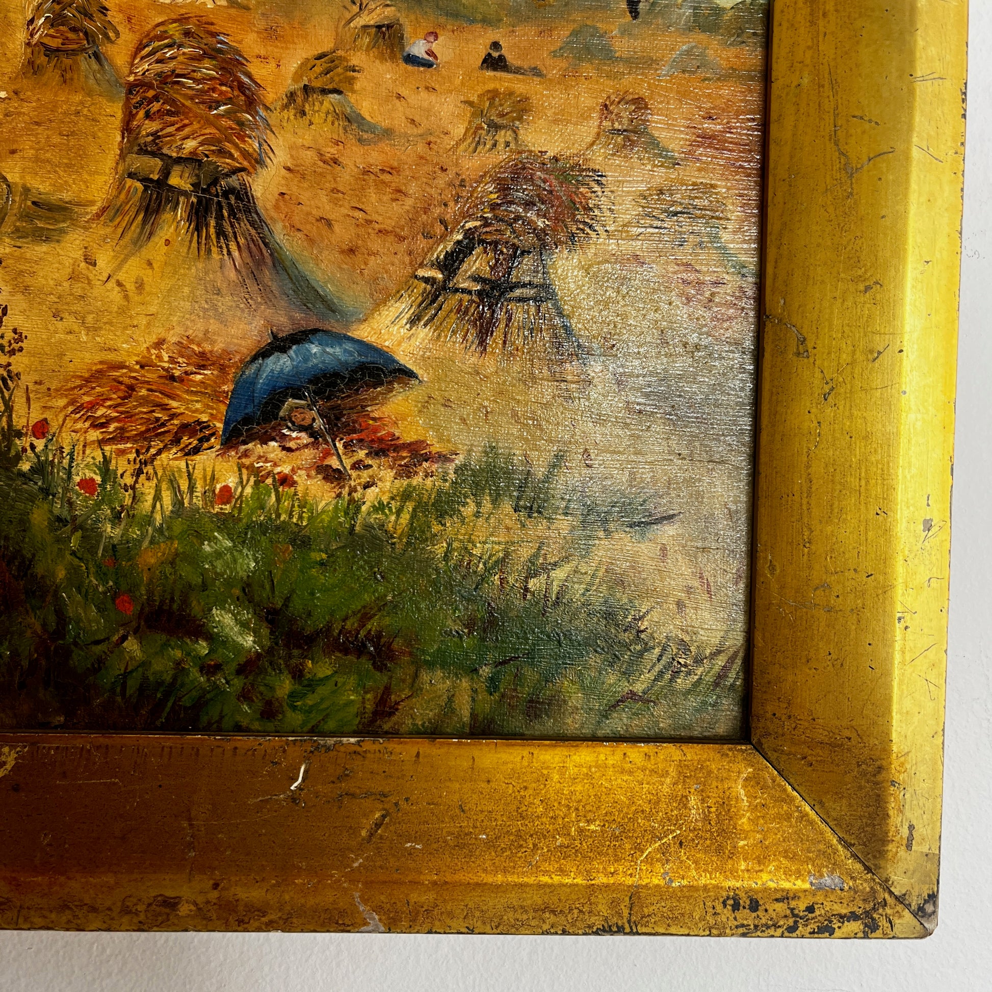 A vintage oil painting on canvas depicting a tranquil coastal scene with blue water, a sandy shoreline, and distant cliffs or headland beneath a softly painted sky. The atmospheric landscape is presented in an ornate gold-coloured frame, adding a classic, elegant touch to the artwork