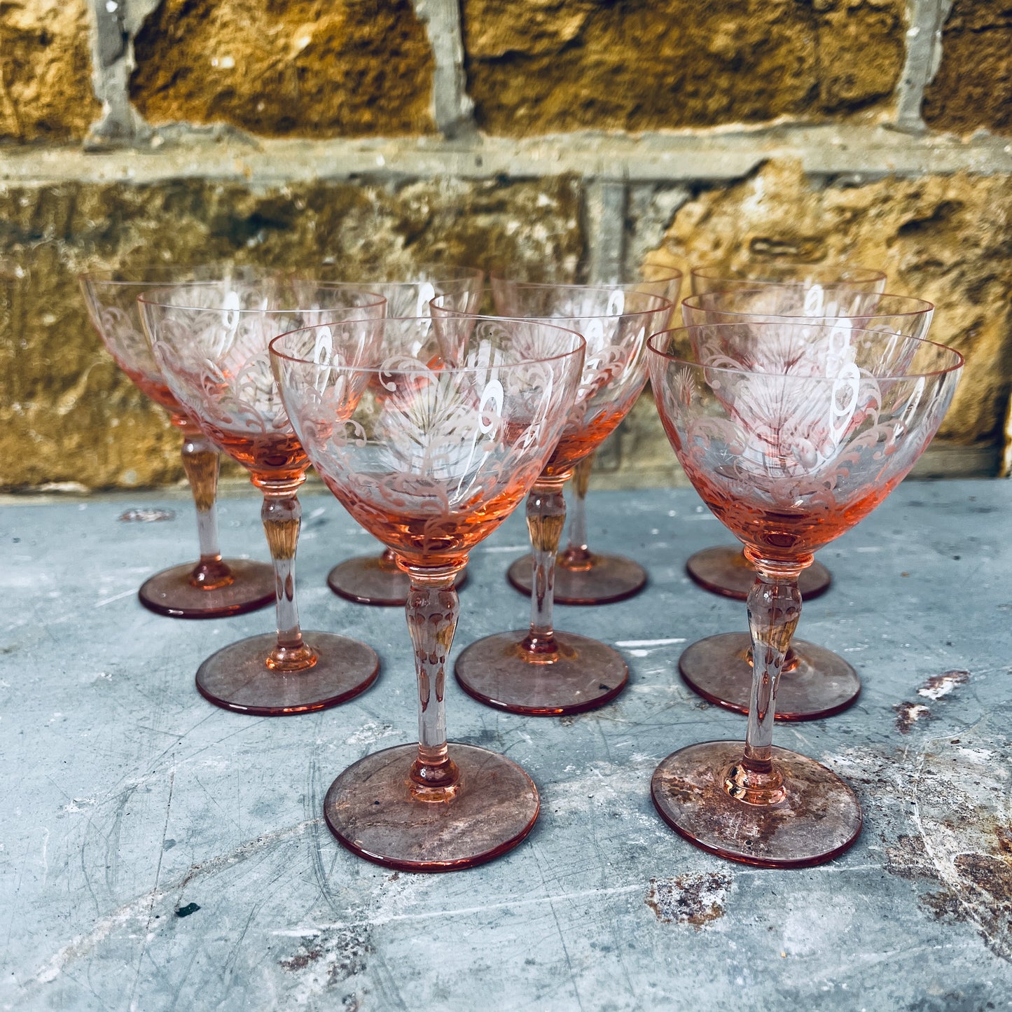 Blush pink depression glass coupes with a delicate, translucent finish. The shallow, rounded bowls feature vintage 1930s design, showcasing elegant, soft pastel tones.