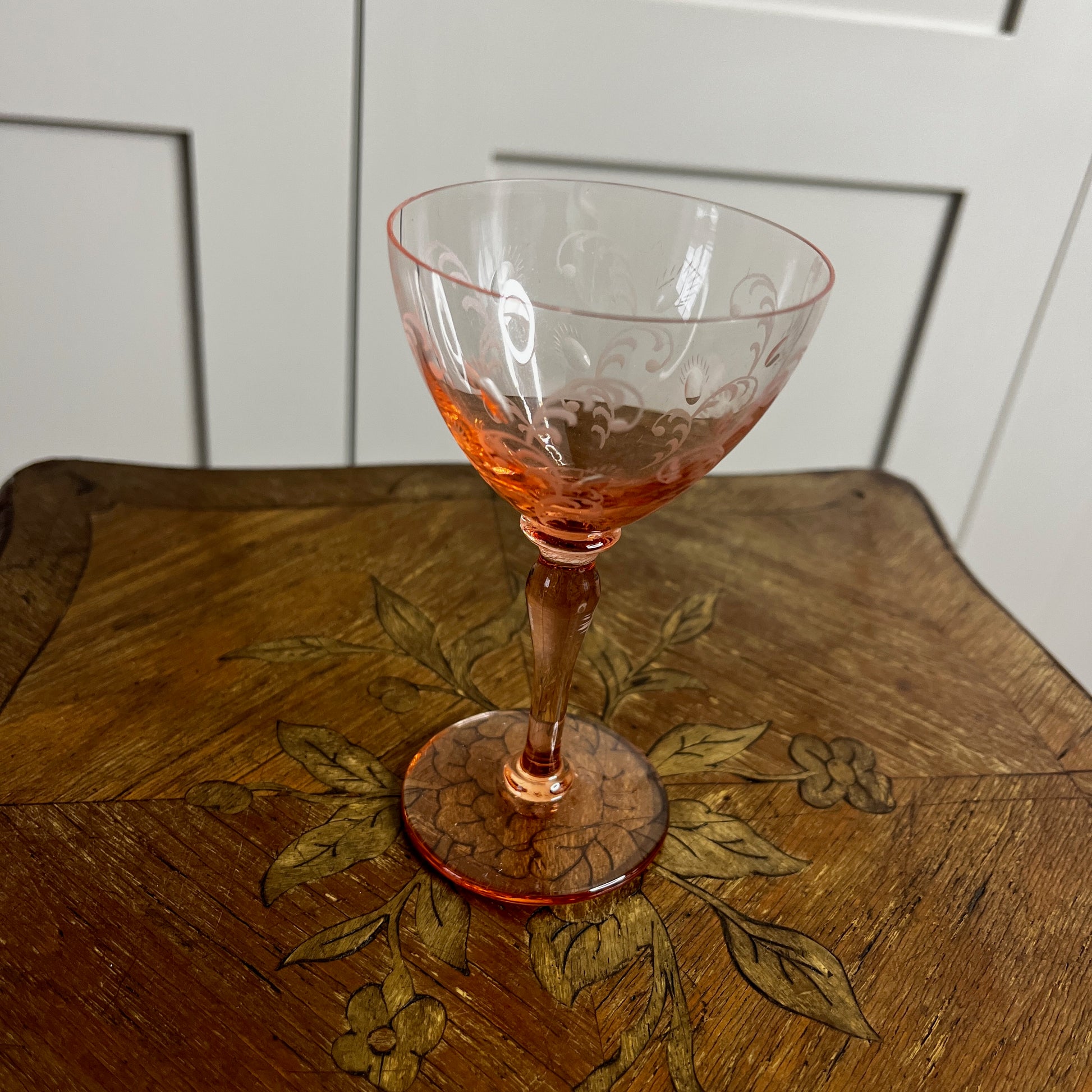 Blush pink depression glass coupes with a delicate, translucent finish. The shallow, rounded bowls feature vintage 1930s design, showcasing elegant, soft pastel tones.