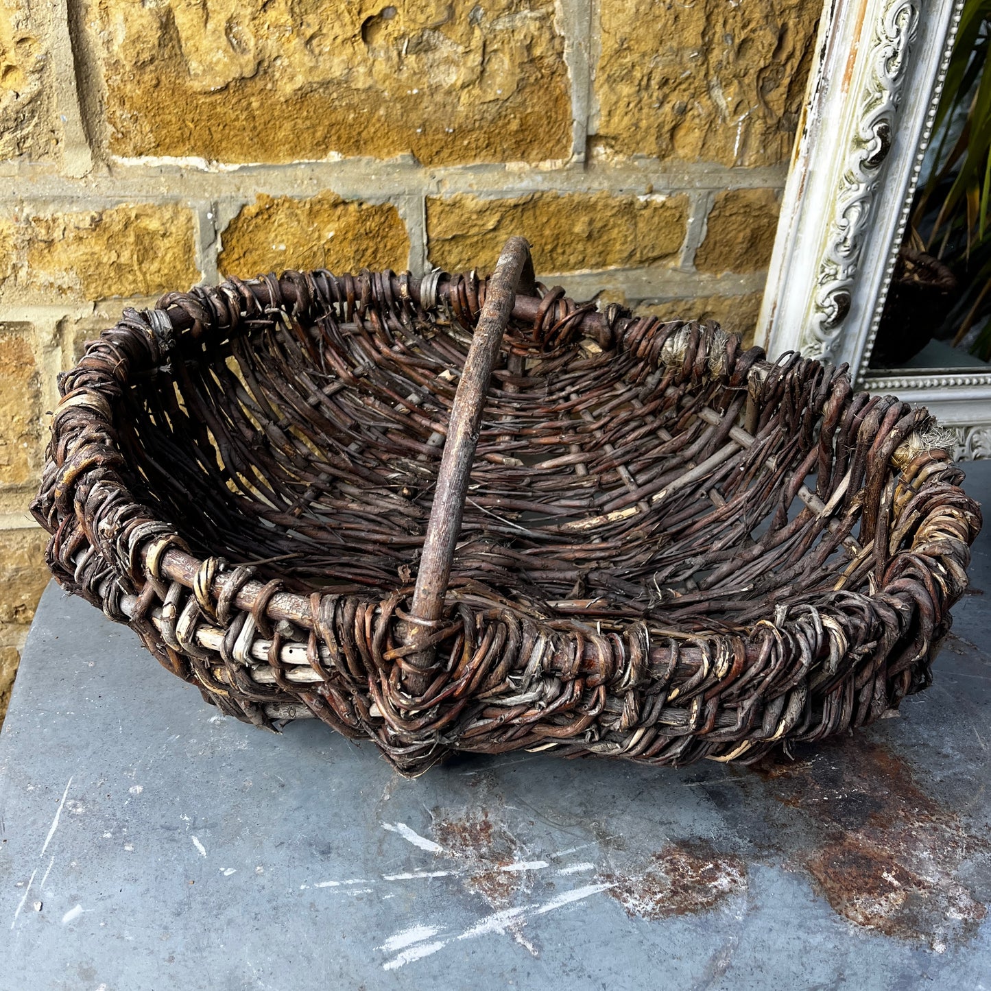 Rustic French wicker baskets with hand-woven construction and a natural, weathered finish. The baskets feature sturdy handles and textured surfaces, reflecting traditional French country craftsmanship.