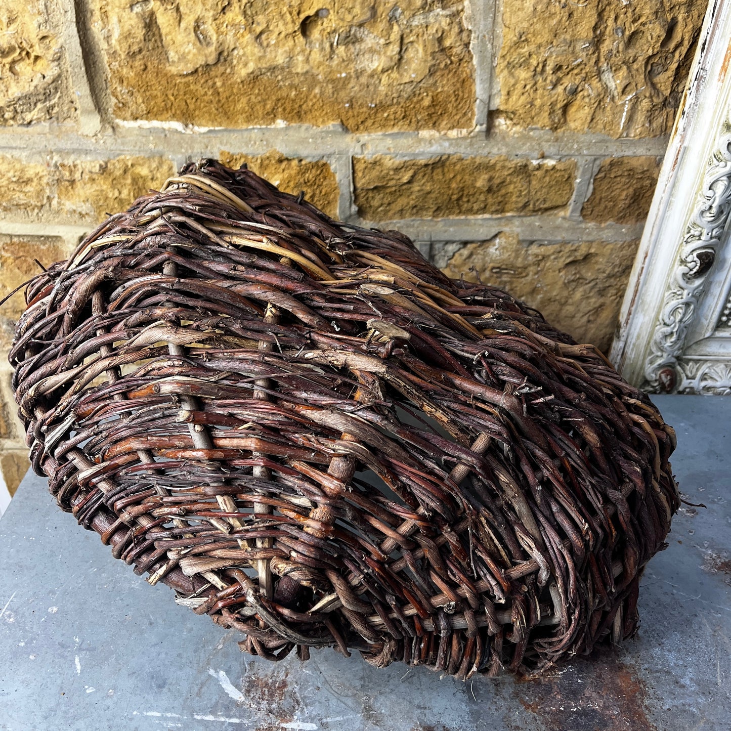 Rustic French wicker baskets with hand-woven construction and a natural, weathered finish. The baskets feature sturdy handles and textured surfaces, reflecting traditional French country craftsmanship.