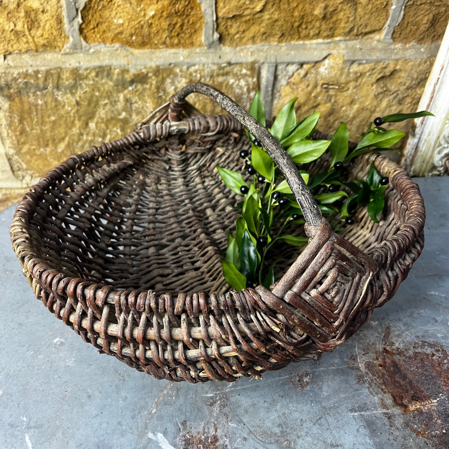 Rustic French wicker baskets with hand-woven construction and a natural, weathered finish. The baskets feature sturdy handles and textured surfaces, reflecting traditional French country craftsmanship.