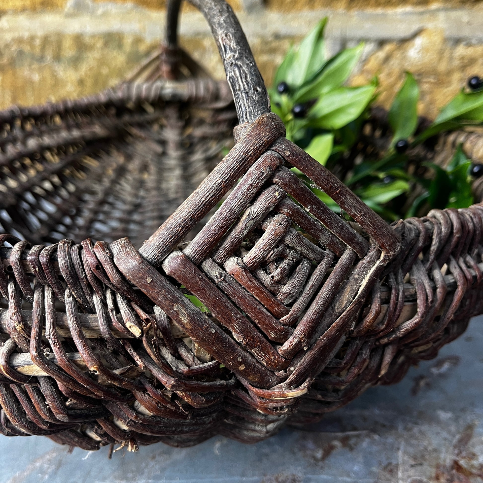 Rustic French wicker baskets with hand-woven construction and a natural, weathered finish. The baskets feature sturdy handles and textured surfaces, reflecting traditional French country craftsmanship.