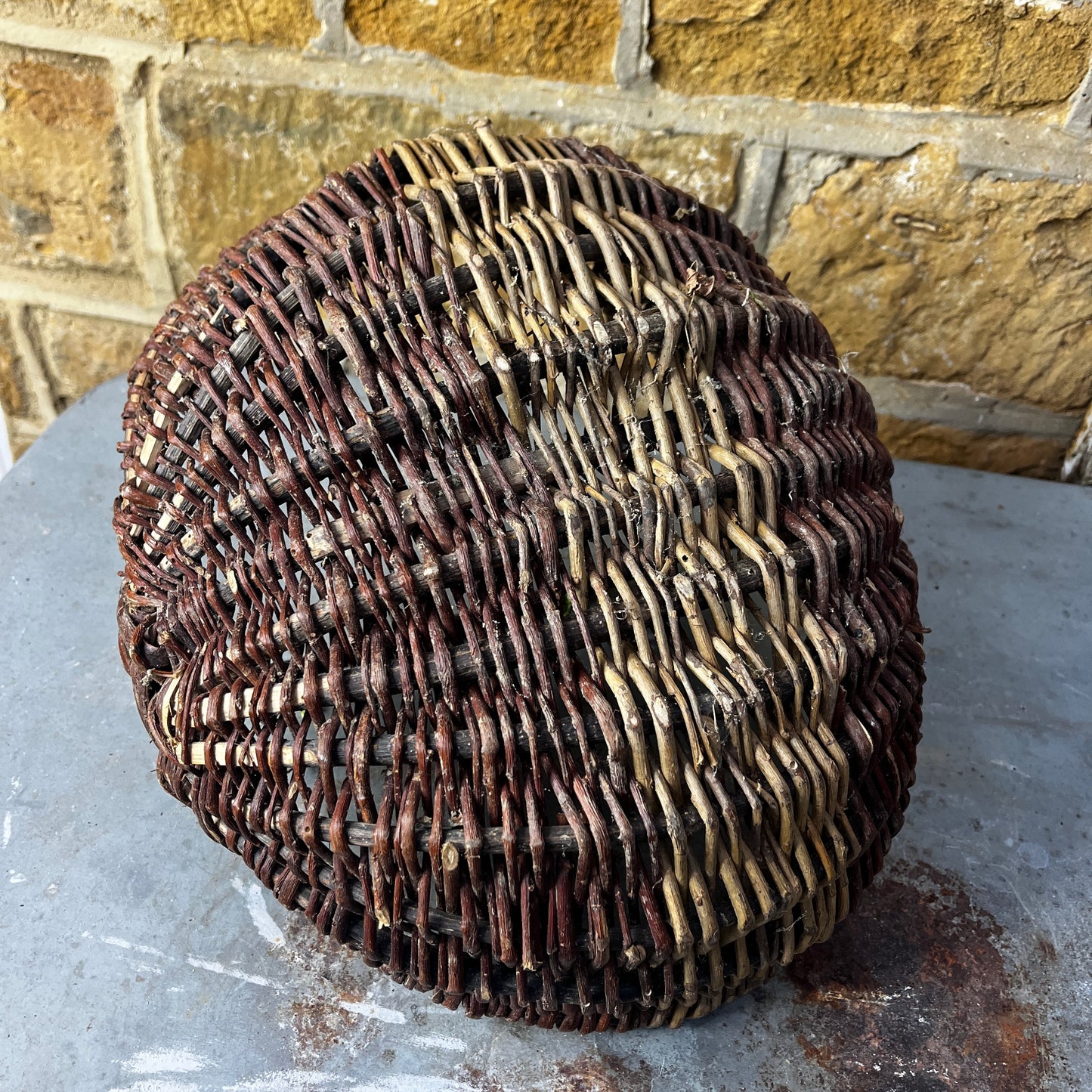 Rustic French wicker baskets with hand-woven construction and a natural, weathered finish. The baskets feature sturdy handles and textured surfaces, reflecting traditional French country craftsmanship.