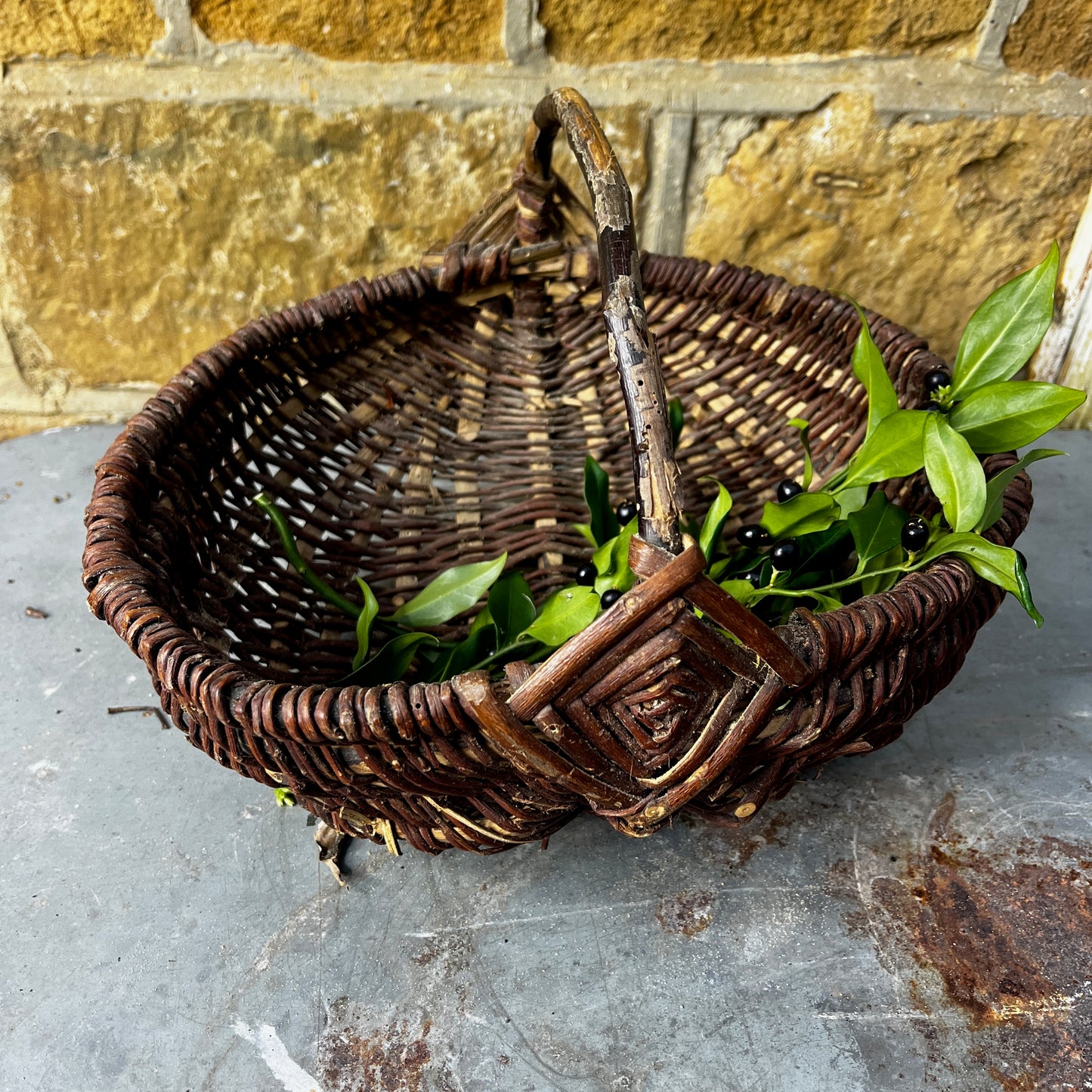 Rustic French wicker baskets with hand-woven construction and a natural, weathered finish. The baskets feature sturdy handles and textured surfaces, reflecting traditional French country craftsmanship.