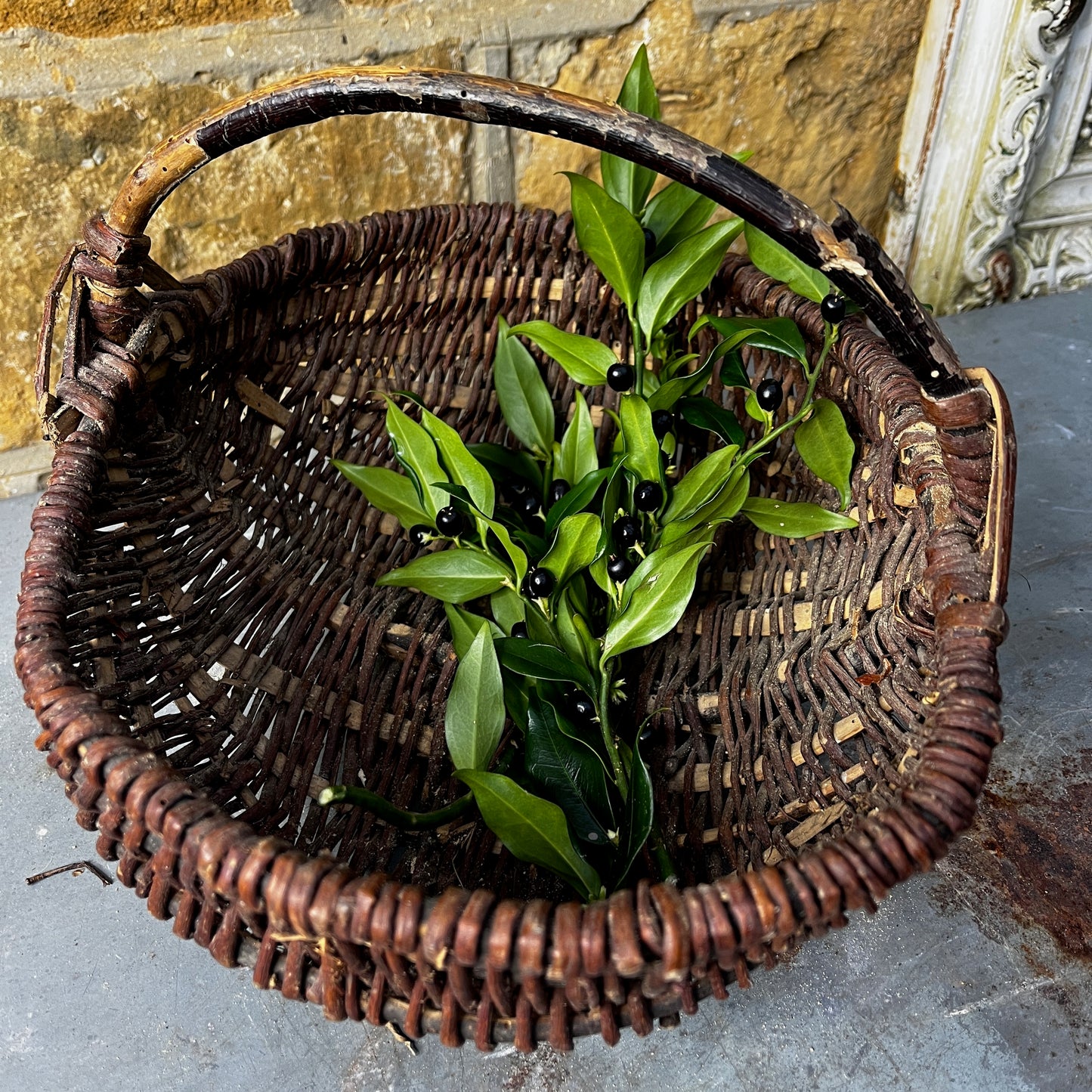 Rustic French wicker baskets with hand-woven construction and a natural, weathered finish. The baskets feature sturdy handles and textured surfaces, reflecting traditional French country craftsmanship.