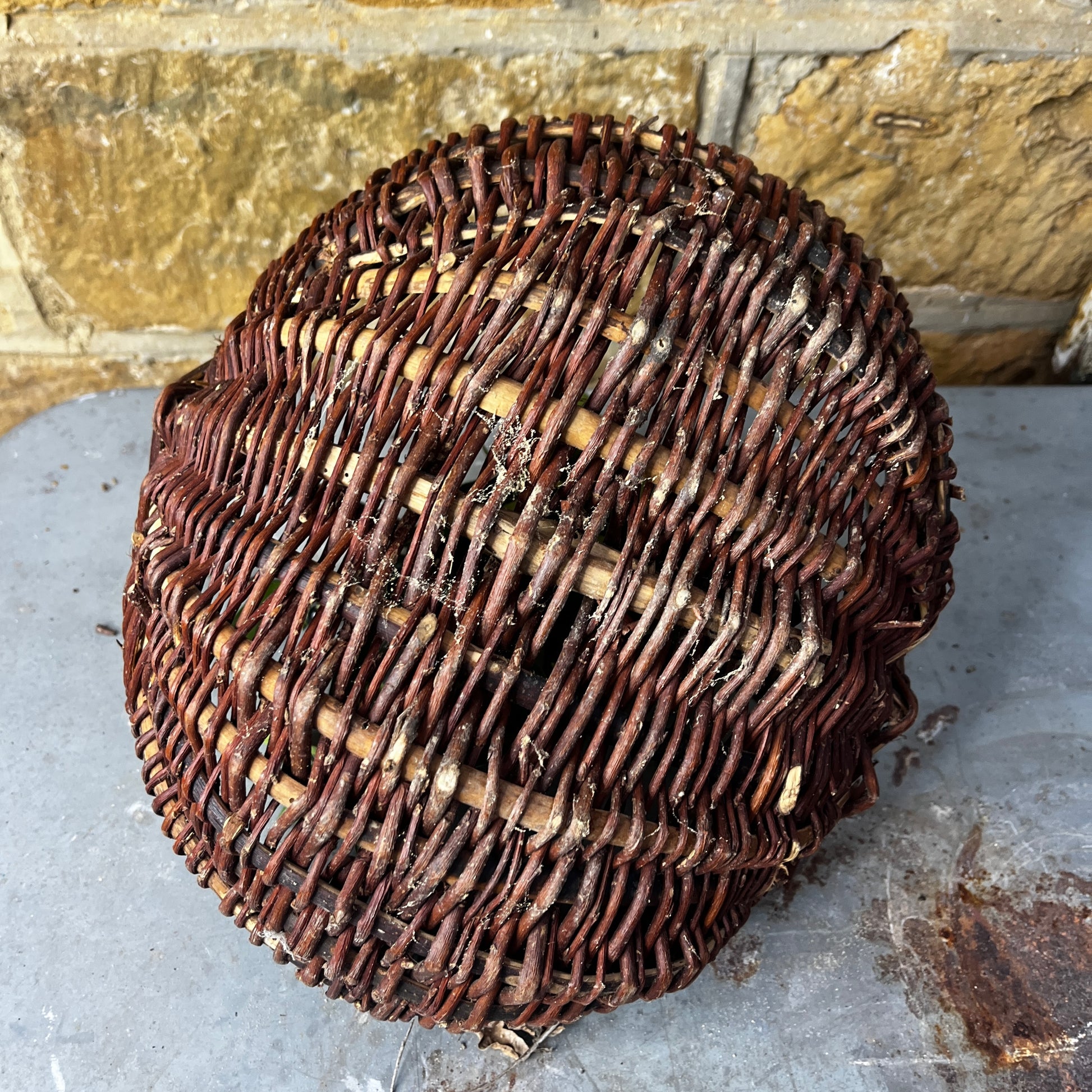 Rustic French wicker baskets with hand-woven construction and a natural, weathered finish. The baskets feature sturdy handles and textured surfaces, reflecting traditional French country craftsmanship.