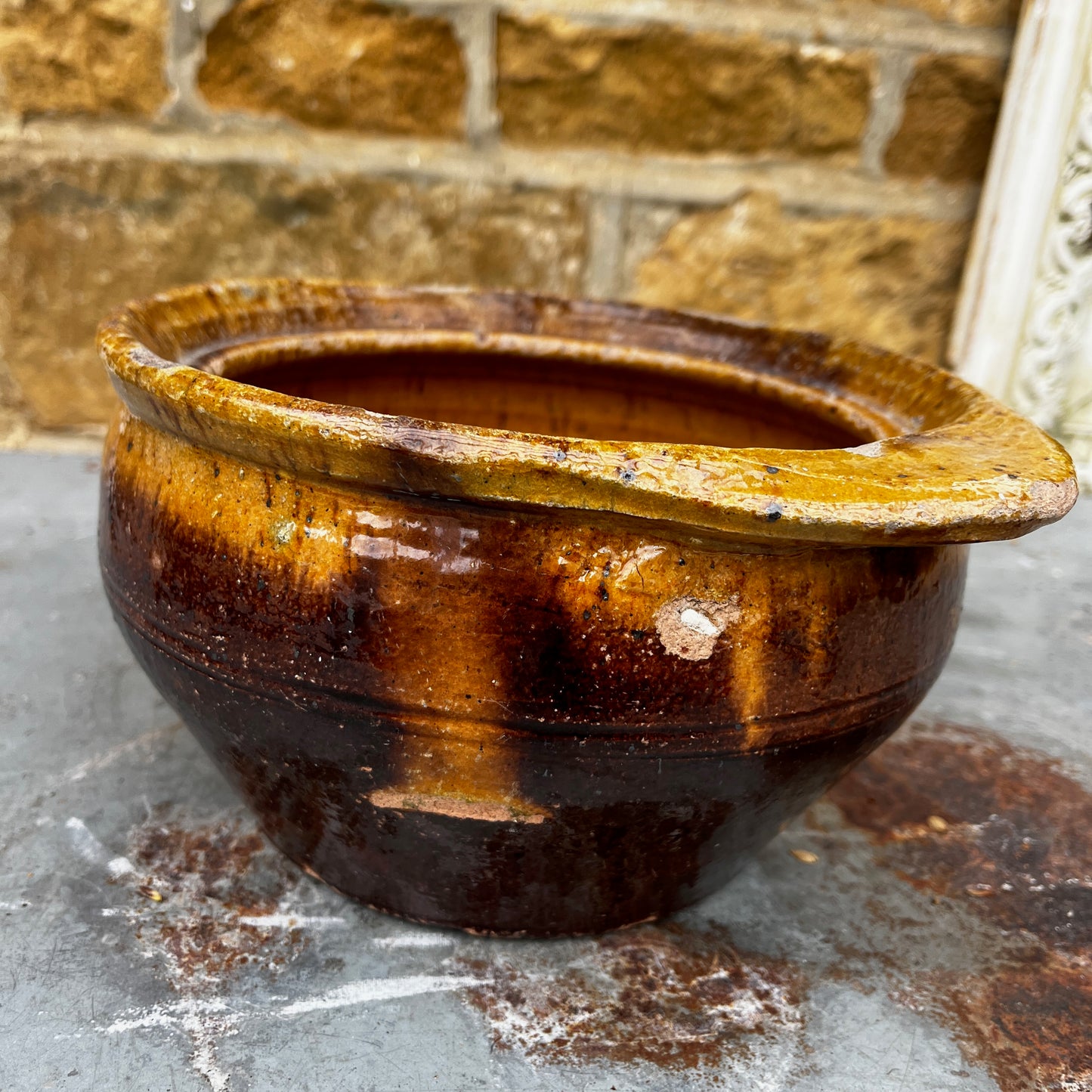 A Rustic, Glazed Redware Pot With Mottled Brown and Amber Colouration
