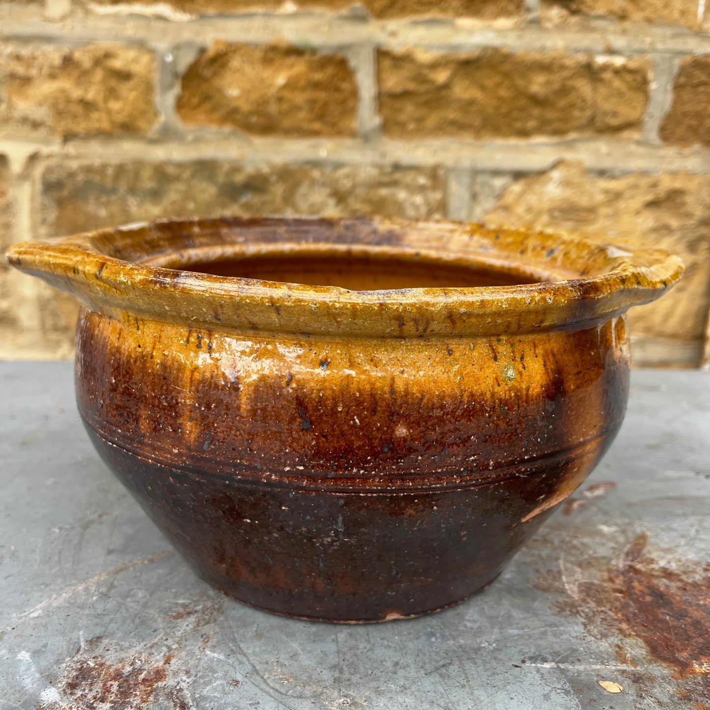 A Rustic, Glazed Redware Pot With Mottled Brown and Amber Colouration