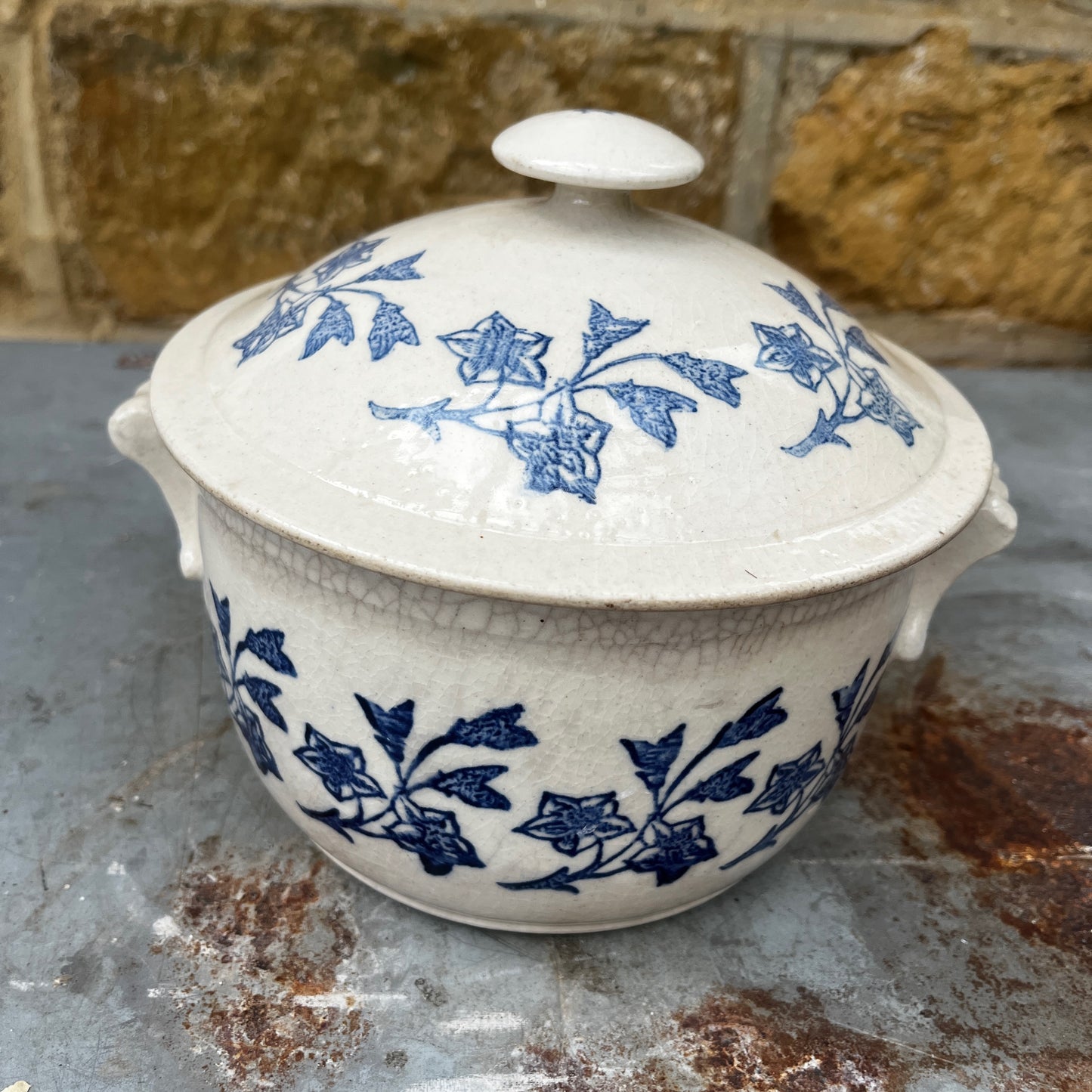 An antique French Saint-Uze lidded tureen in classic blue and white stoneware, decorated with traditional floral transferware patterns.