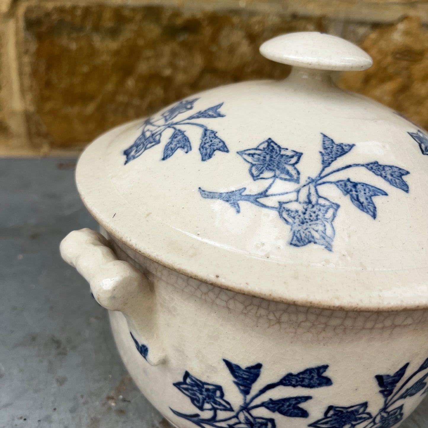 An antique French Saint-Uze lidded tureen in classic blue and white stoneware, decorated with traditional floral transferware patterns.