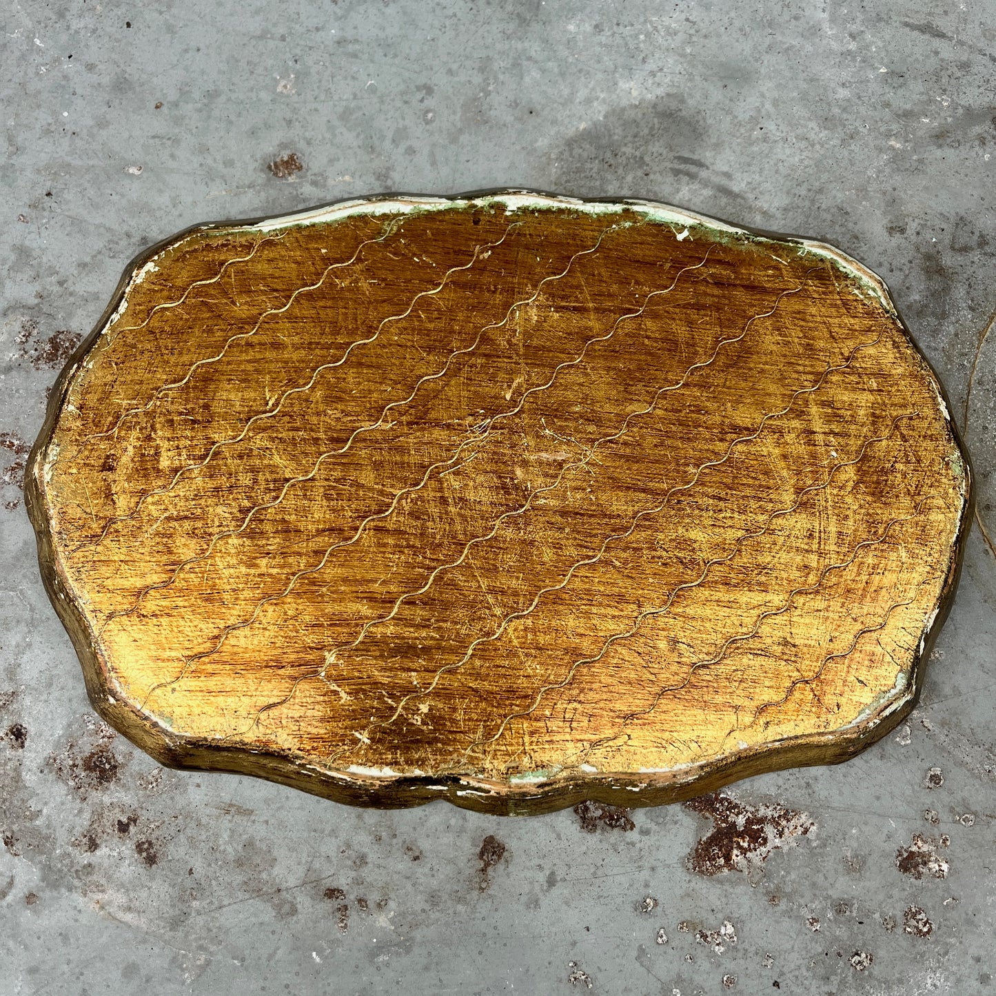 Decorative gold and blue tray on a textured surface