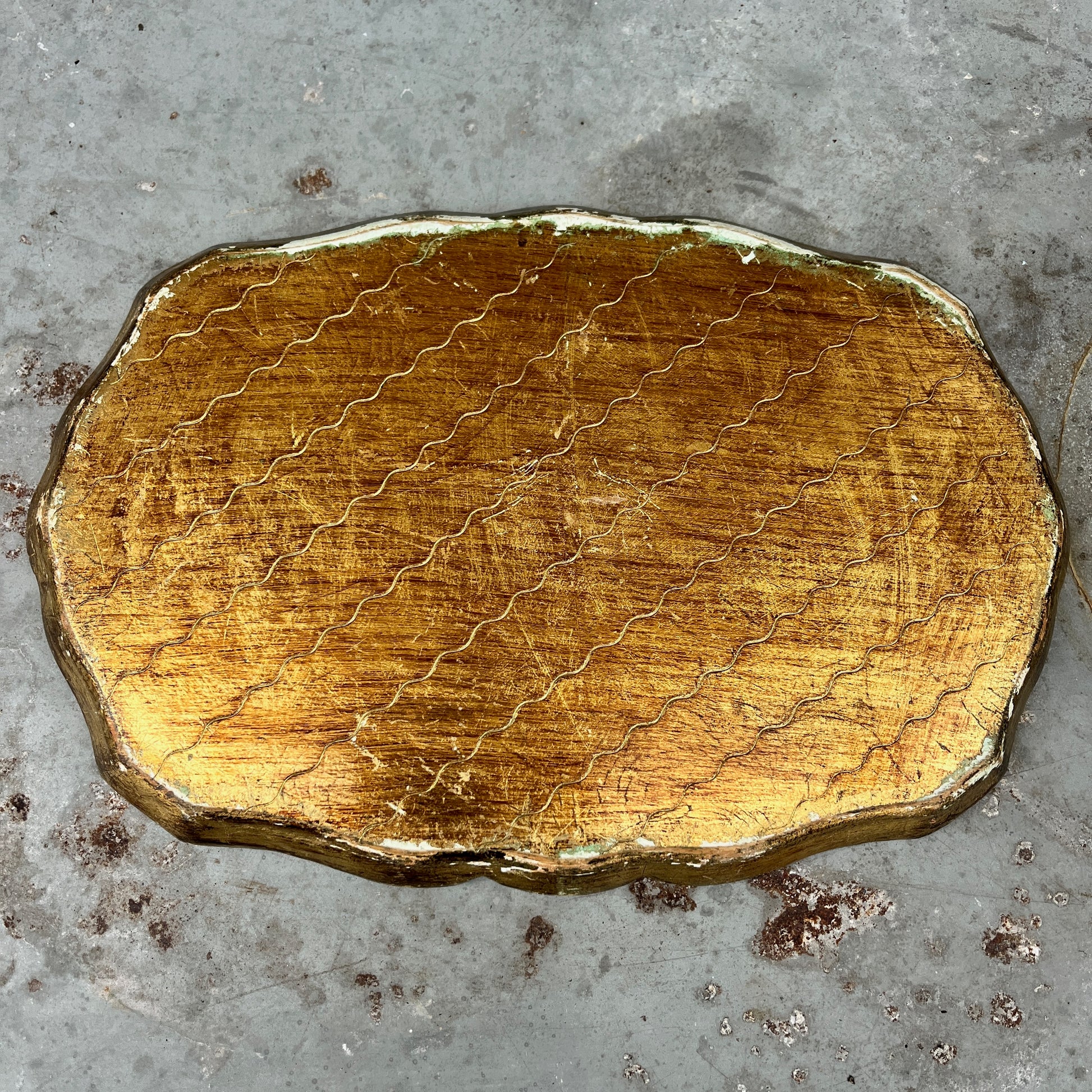 Decorative gold and blue tray on a textured surface