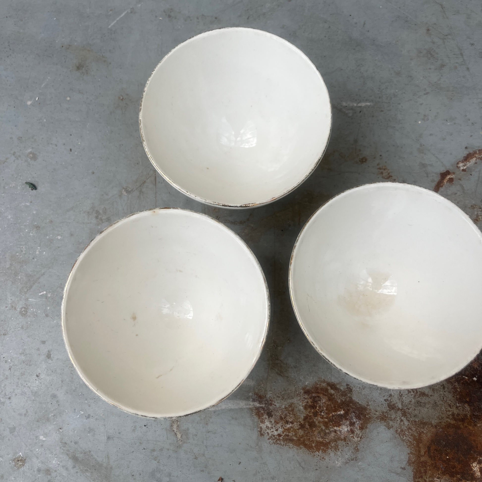 A small vintage French ceramic bowl with a delicate rose decoration in soft pink and green tones