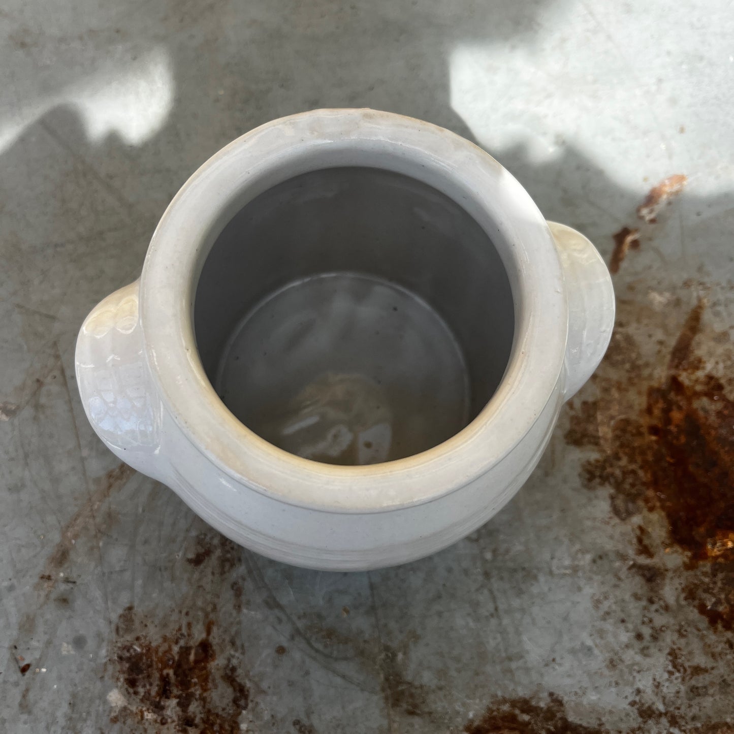 A small vintage white confit pot with a classic rounded shape and a beautifully aged glazed finish.