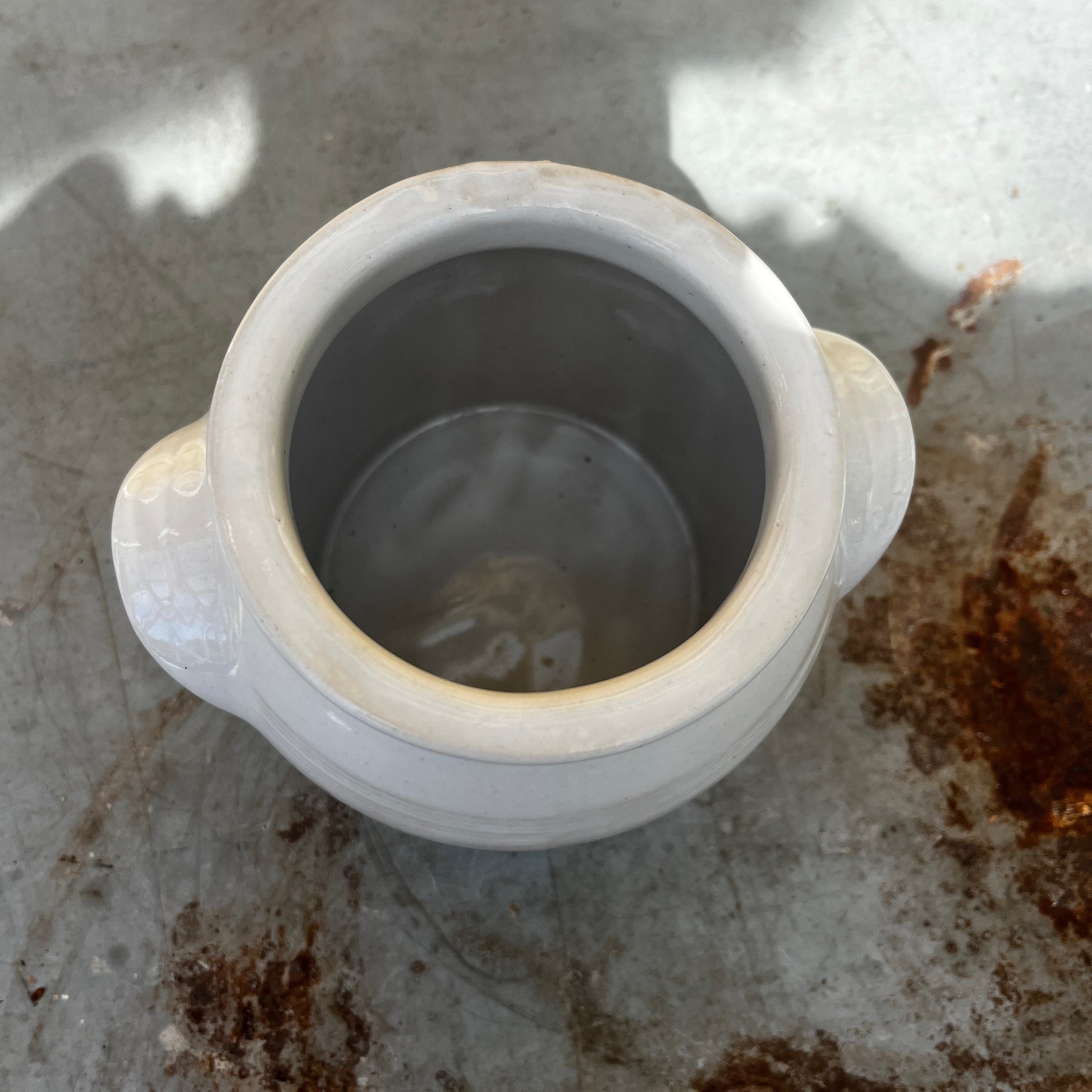 A small vintage white confit pot with a classic rounded shape and a beautifully aged glazed finish.