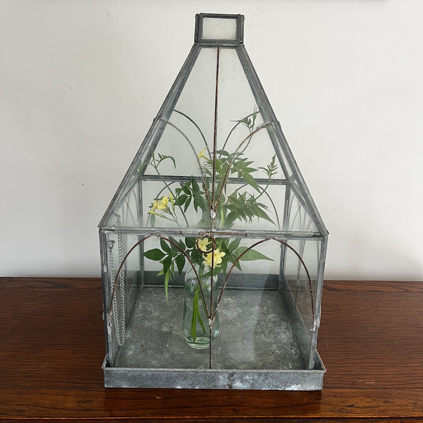 Vintage-style glass terrarium with a decorative frame and classic antique-inspired design