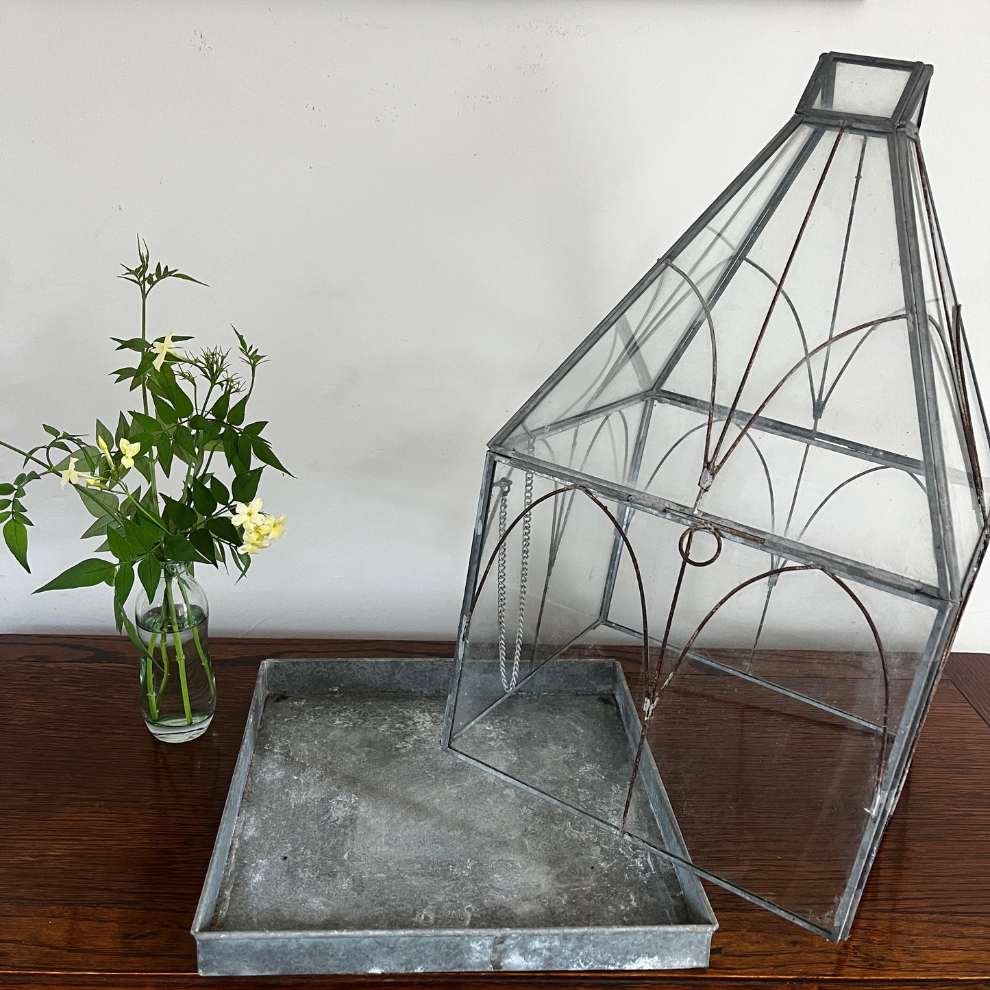 Vintage-style glass terrarium with a decorative frame and classic antique-inspired design