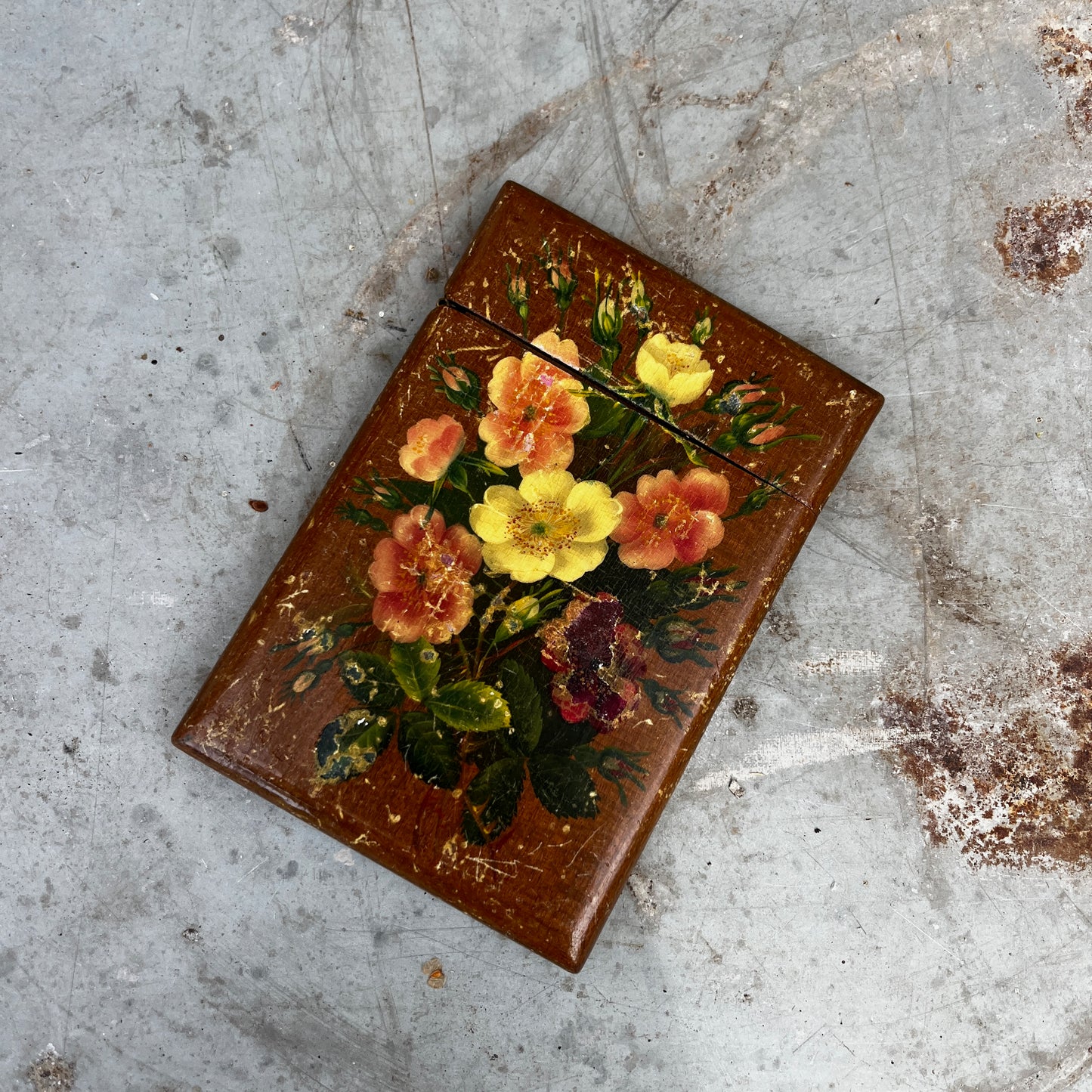 A small vintage wooden toleware box designed to hold business cards, featuring a hand-painted finish and decorative floral motifs. The rectangular box has a hinged lid and a gently aged patina