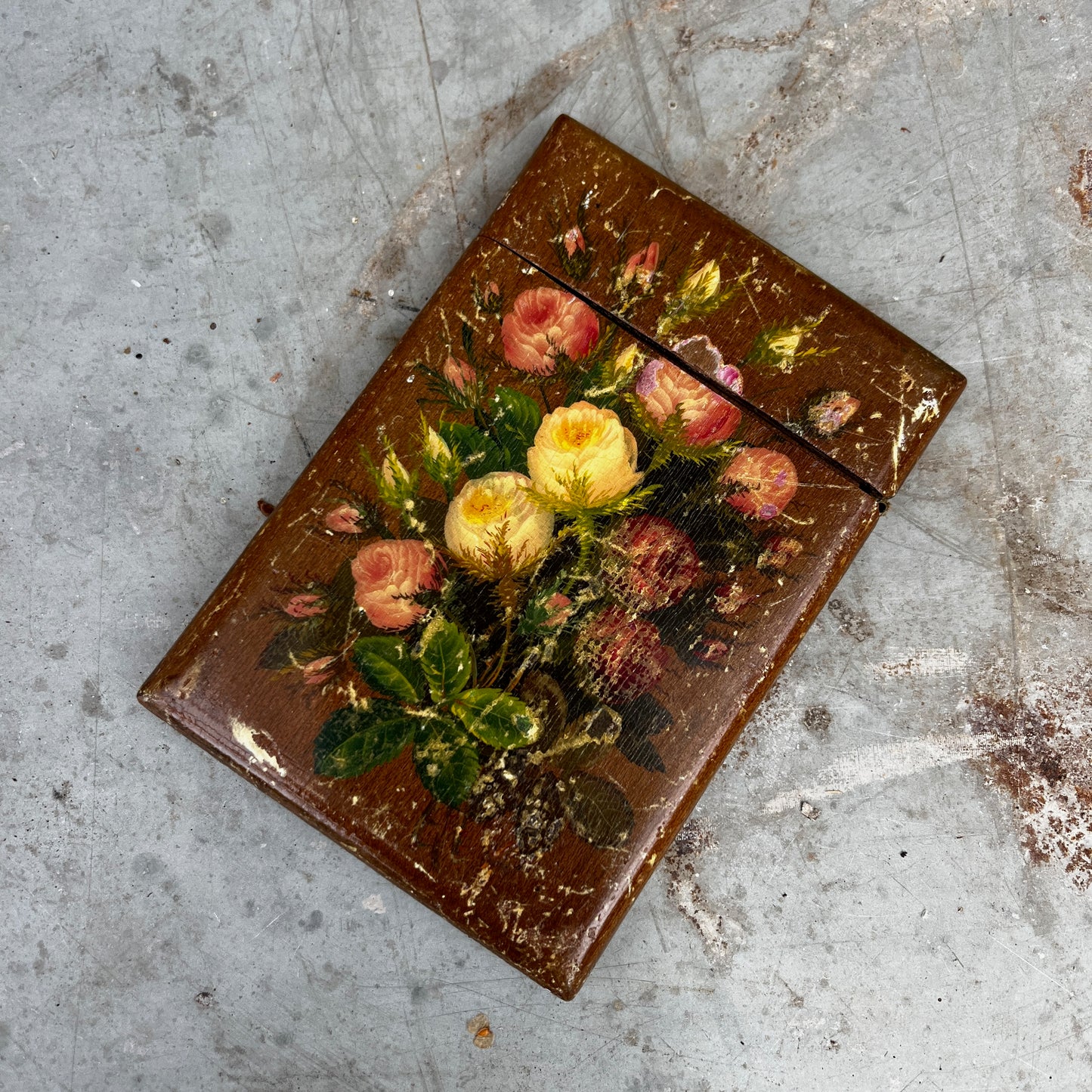 A small vintage wooden toleware box designed to hold business cards, featuring a hand-painted finish and decorative floral motifs. The rectangular box has a hinged lid and a gently aged patina