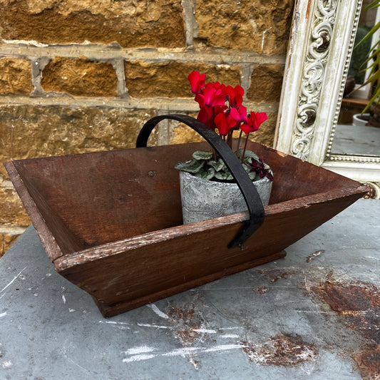 Rustic wooden trug with a black metal handle.