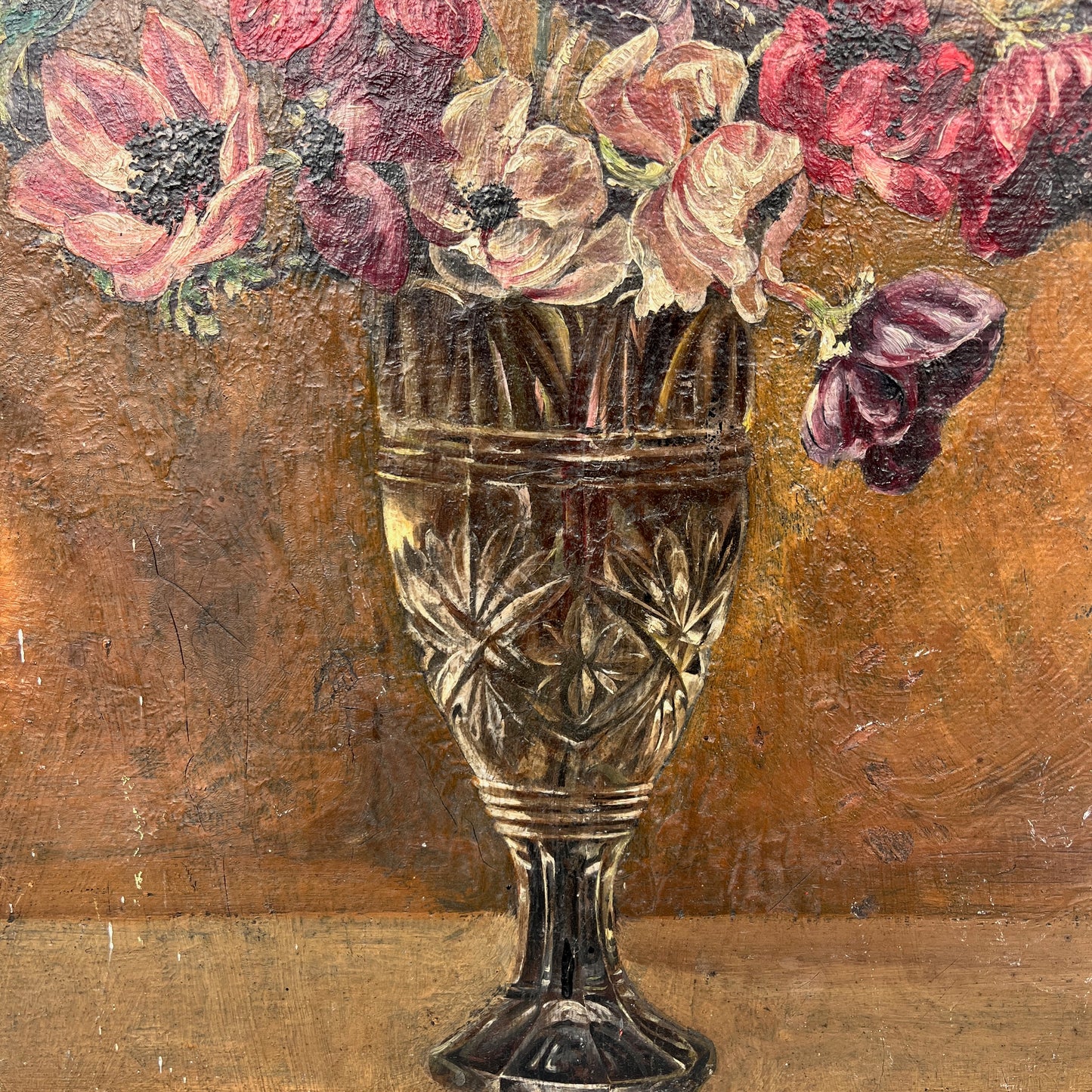 Decorative glass vase with flowers against a textured brown background