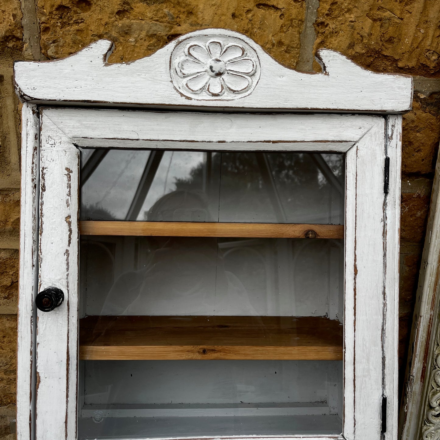 A French wall cupboard with a glazed glass door, two interior shelves, a single drawer, and practical hooks beneath. Its compact proportions and timeless rustic character make it ideal for use as a kitchen, bathroom, or hallway cabinet.