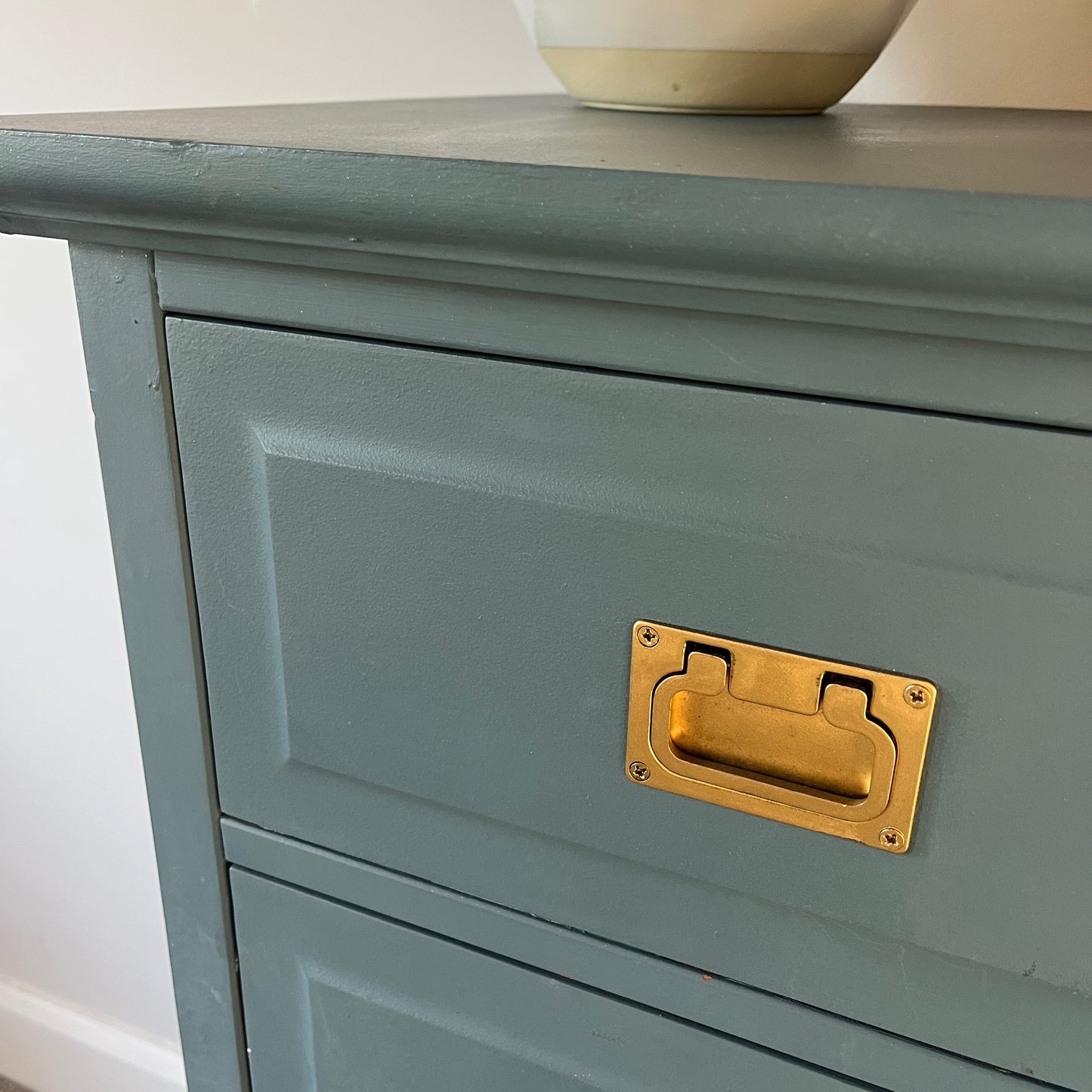 Vintage tallboy painted in striking blue, accented with gold square handles, offering a bold yet elegant storage solution with a classic charm
