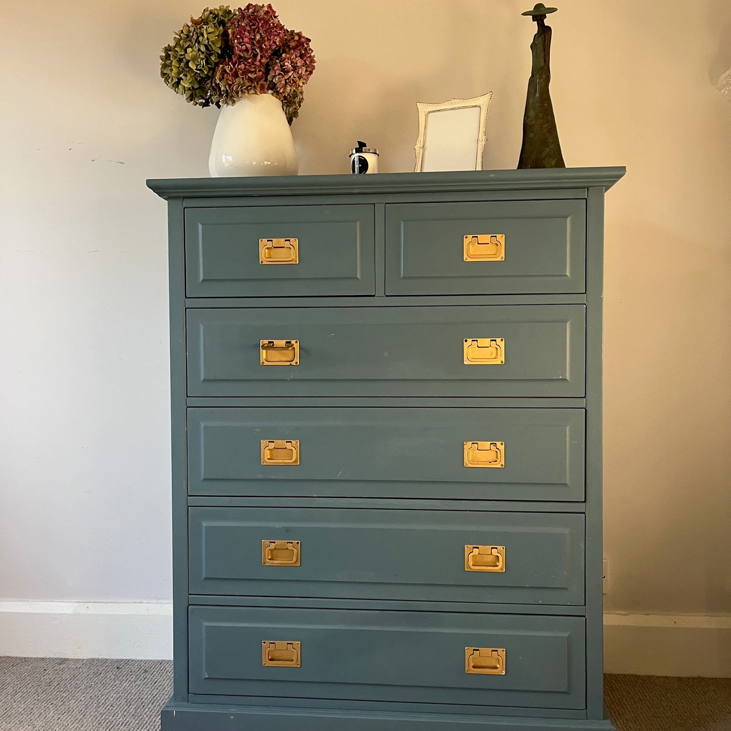 Vintage tallboy painted in striking blue, accented with gold square handles, offering a bold yet elegant storage solution with a classic charm