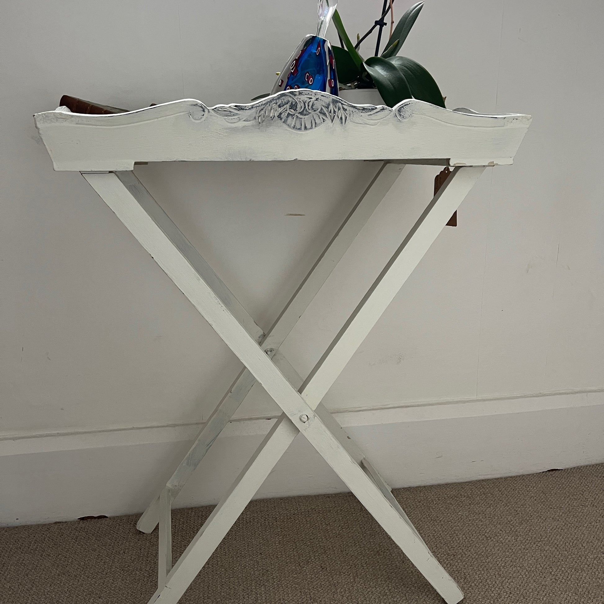 A white butler‚Äôs tray, which has been painted and distressed, featuring a rectangular shape with raised edges and two sturdy handles on either side, designed for versatile serving or display.