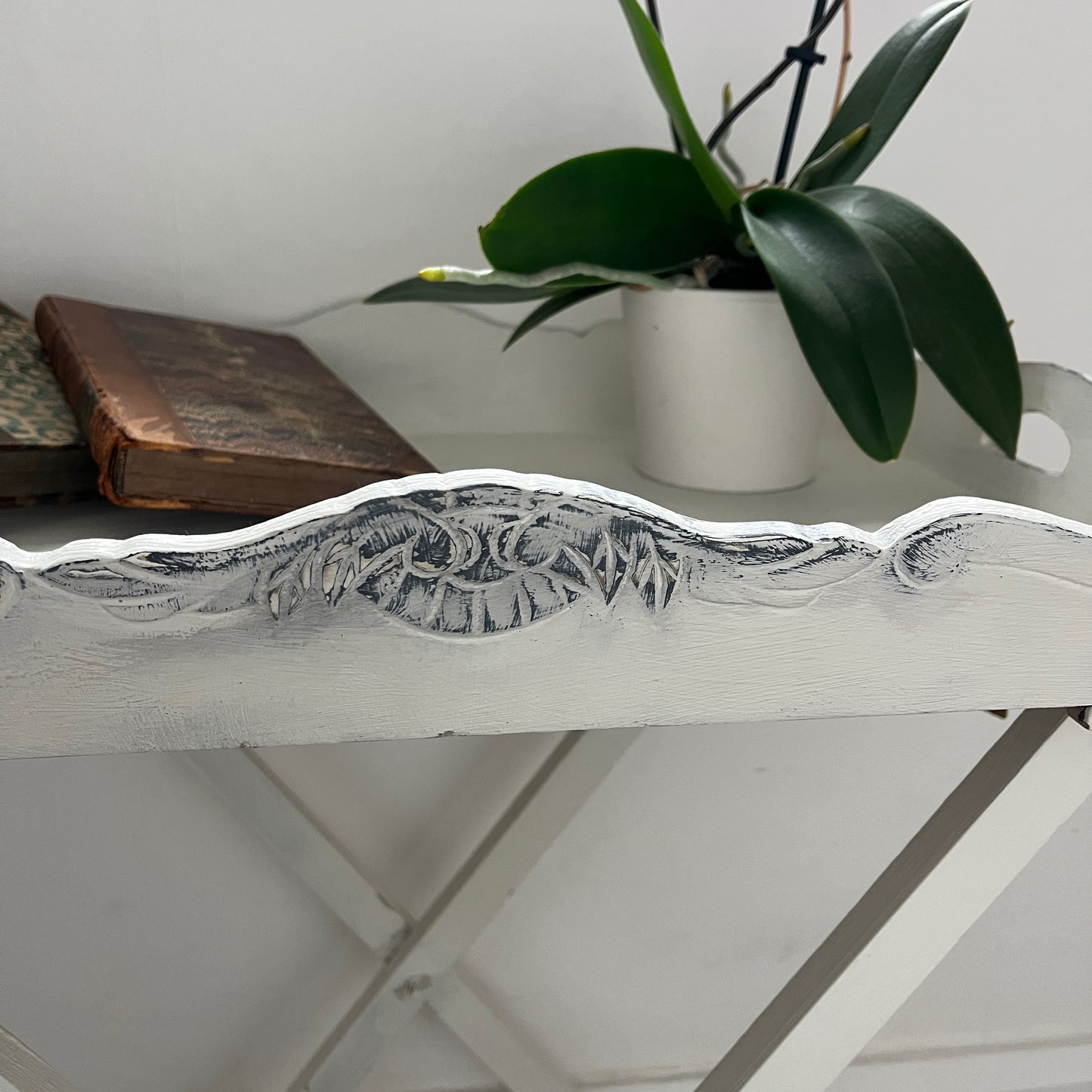 A white butler‚Äôs tray, which has been painted and distressed, featuring a rectangular shape with raised edges and two sturdy handles on either side, designed for versatile serving or display.