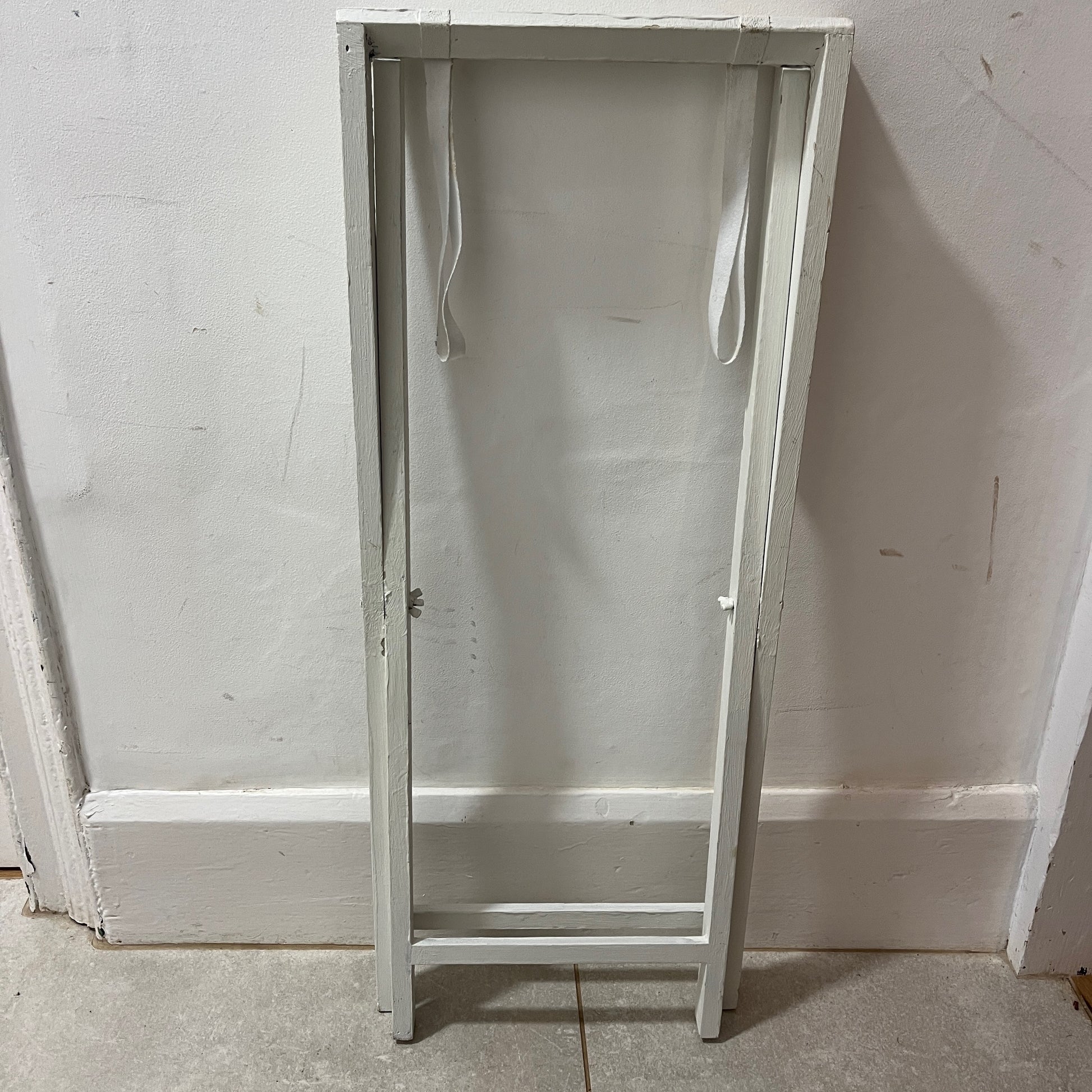 A white butler‚Äôs tray, which has been painted and distressed, featuring a rectangular shape with raised edges and two sturdy handles on either side, designed for versatile serving or display.