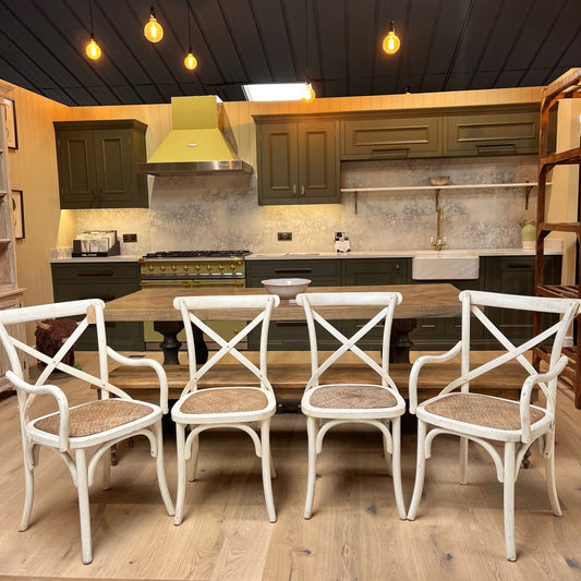 Four French cross-back chairs: two carver chairs with armrests and two standard chairs without, featuring elegant wooden frames and woven cane seats