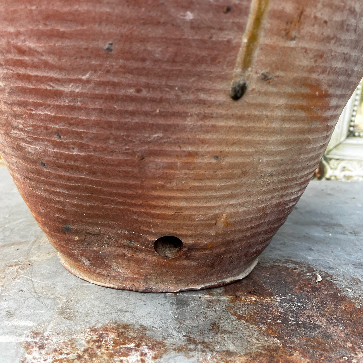 A large handmade ceramic amphora-style vase with a lid, featuring a rustic earthy brown and beige glaze