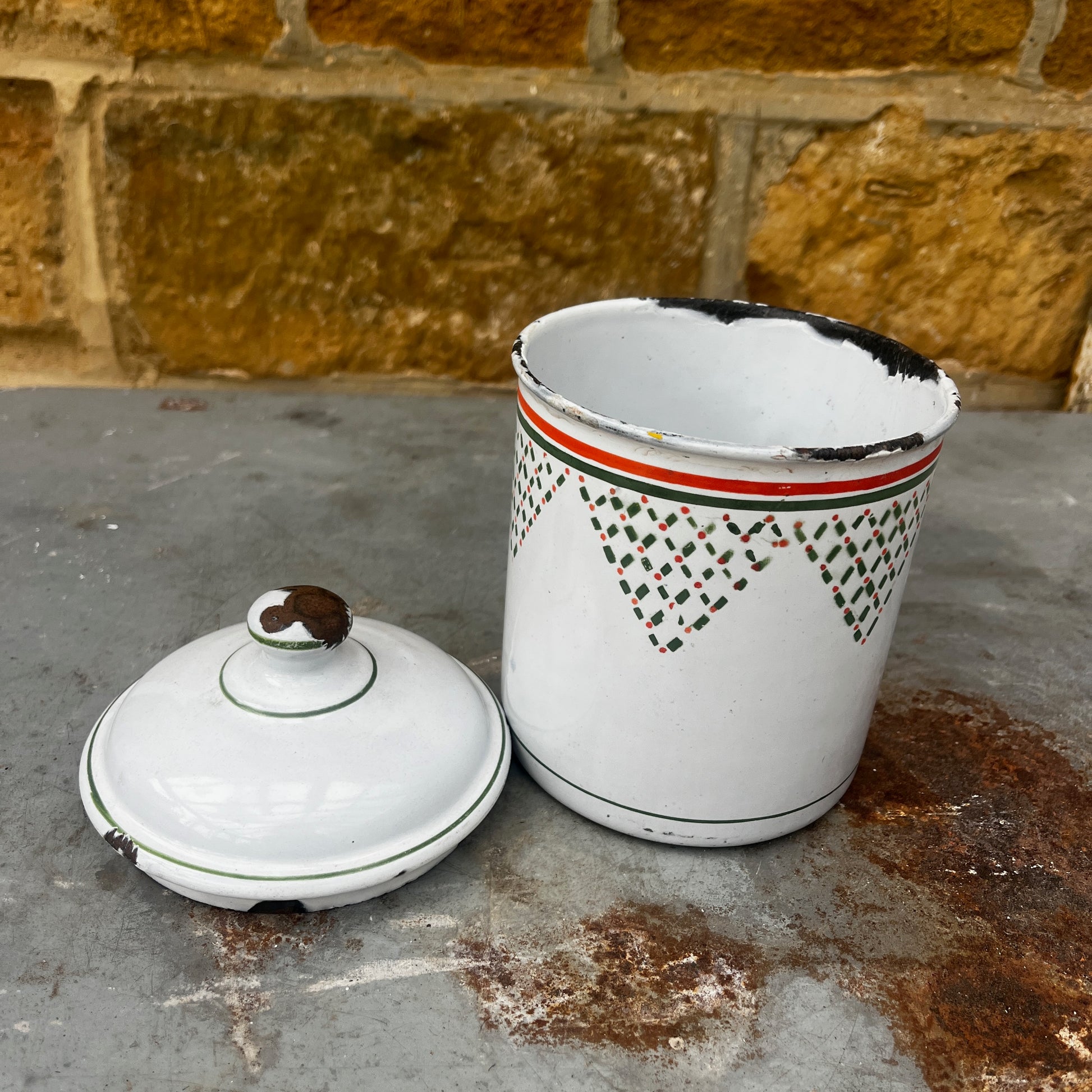 Four vintage white ceramic canisters with lids for flour, coffee, tea, and spices, decorated with green geometric patterns and orange stripes.