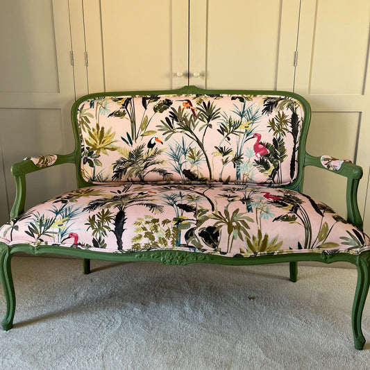 Vintage Italian sofa newly up-holstered in a pink and green tropical velvet fabric, with a green handpainted frame