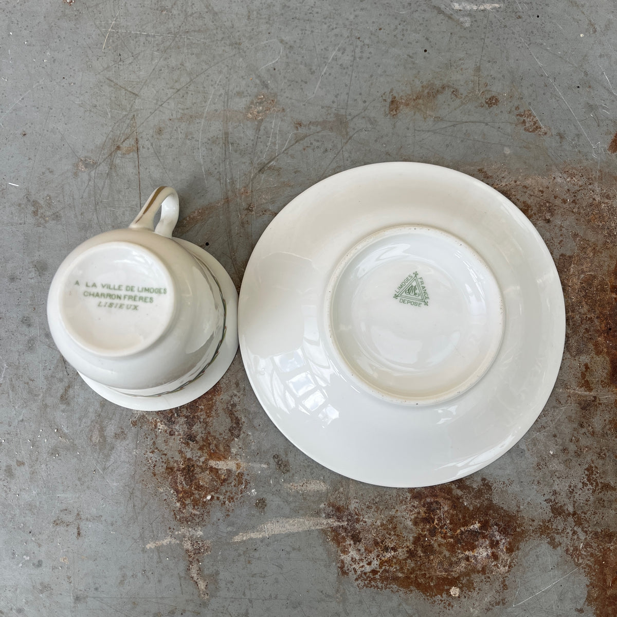 Vintage Limoges porcelain tea set featuring delicate green garland decoration around the rims of the pieces