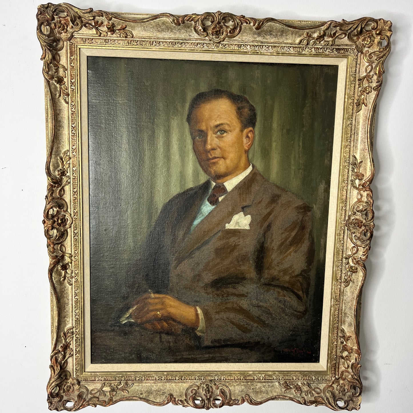 Framed oil on board portrait of a gentleman, signed by the artist. The painting depicts the subject in traditional attire with detailed facial features and a muted background, presented in a classic frame.