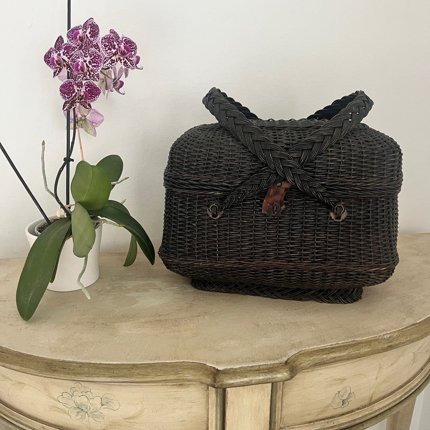 A Parisian handbag crafted from woven materials, showcasing intricate patterns and elegant design, inspired by French style