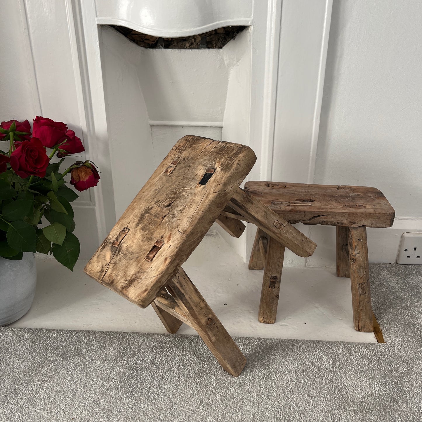 Rustic milking stools with a weathered finish, showcasing simple, sturdy design and vintage countryside charm, perfect for cozy, farmhouse-style decor